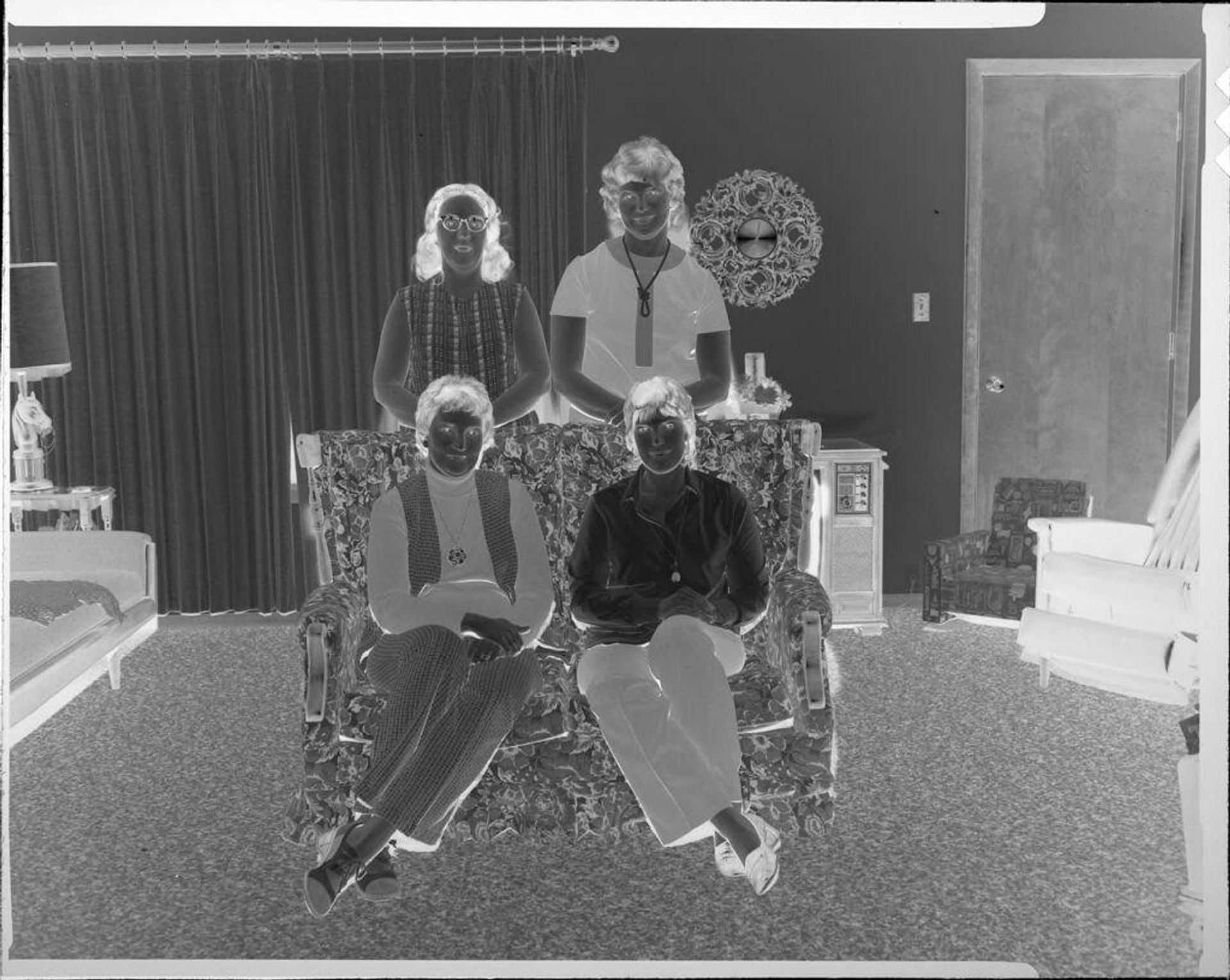 Untitled (portrait of four women in living room) by Ken Whitmire Associates
