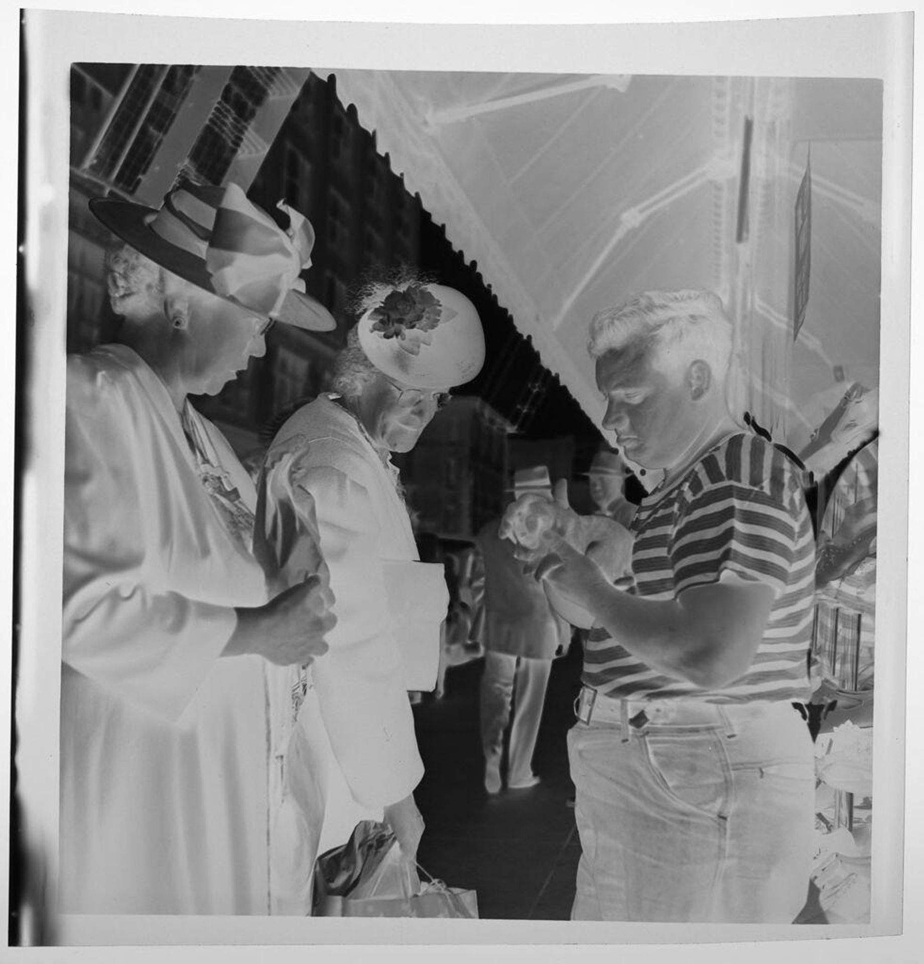 Untitled (man and two women at outdoor market) by Jack Gould