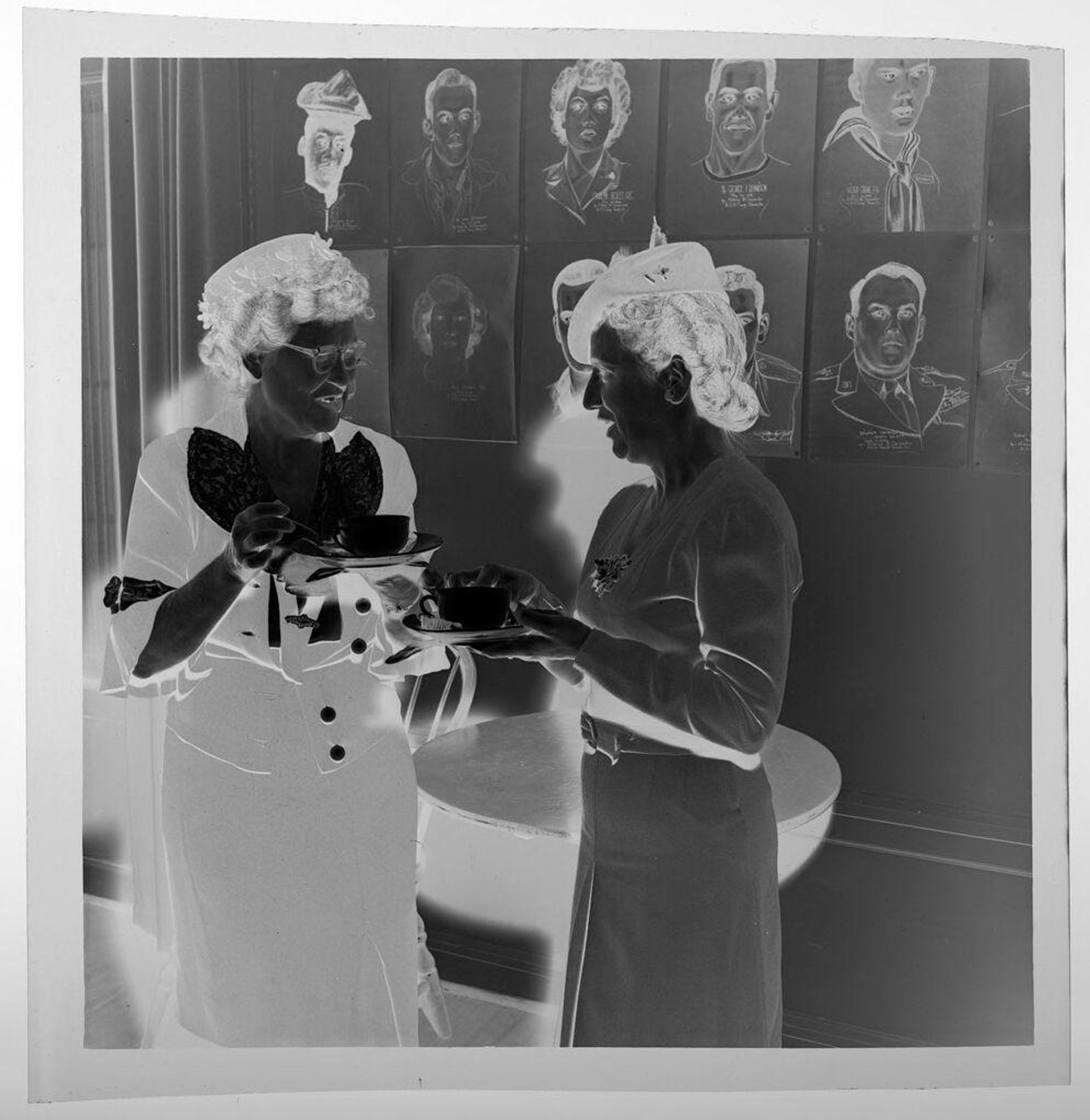 Untitled (two elderly women wearing hats standing and drinking tea) by Jack Gould