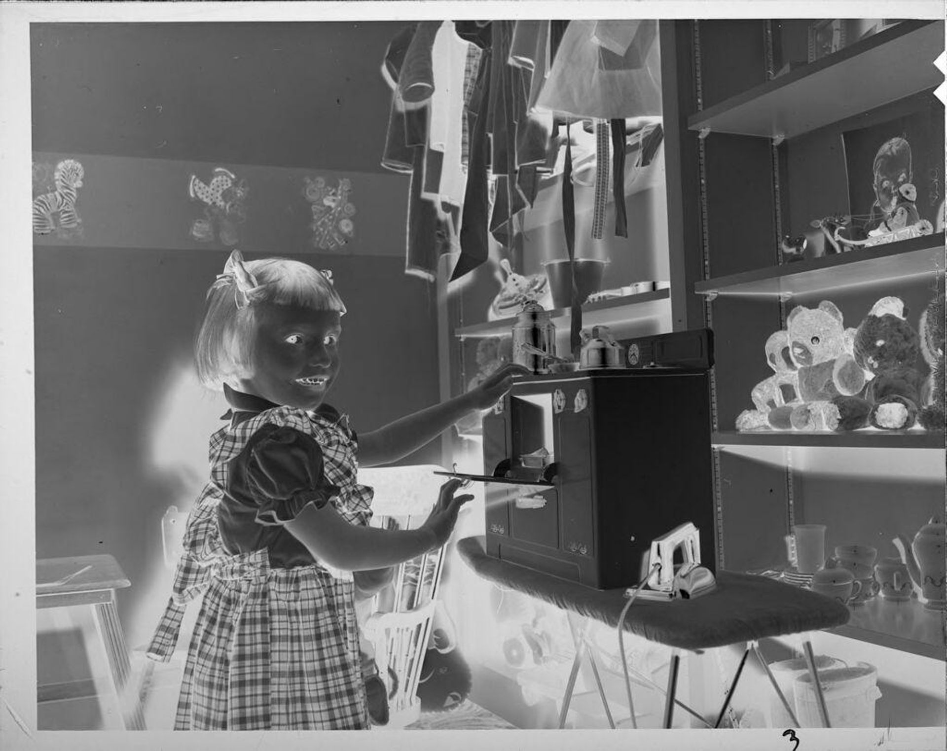 Untitled (girl playing with toy oven) by Lucian and Mary Brown
