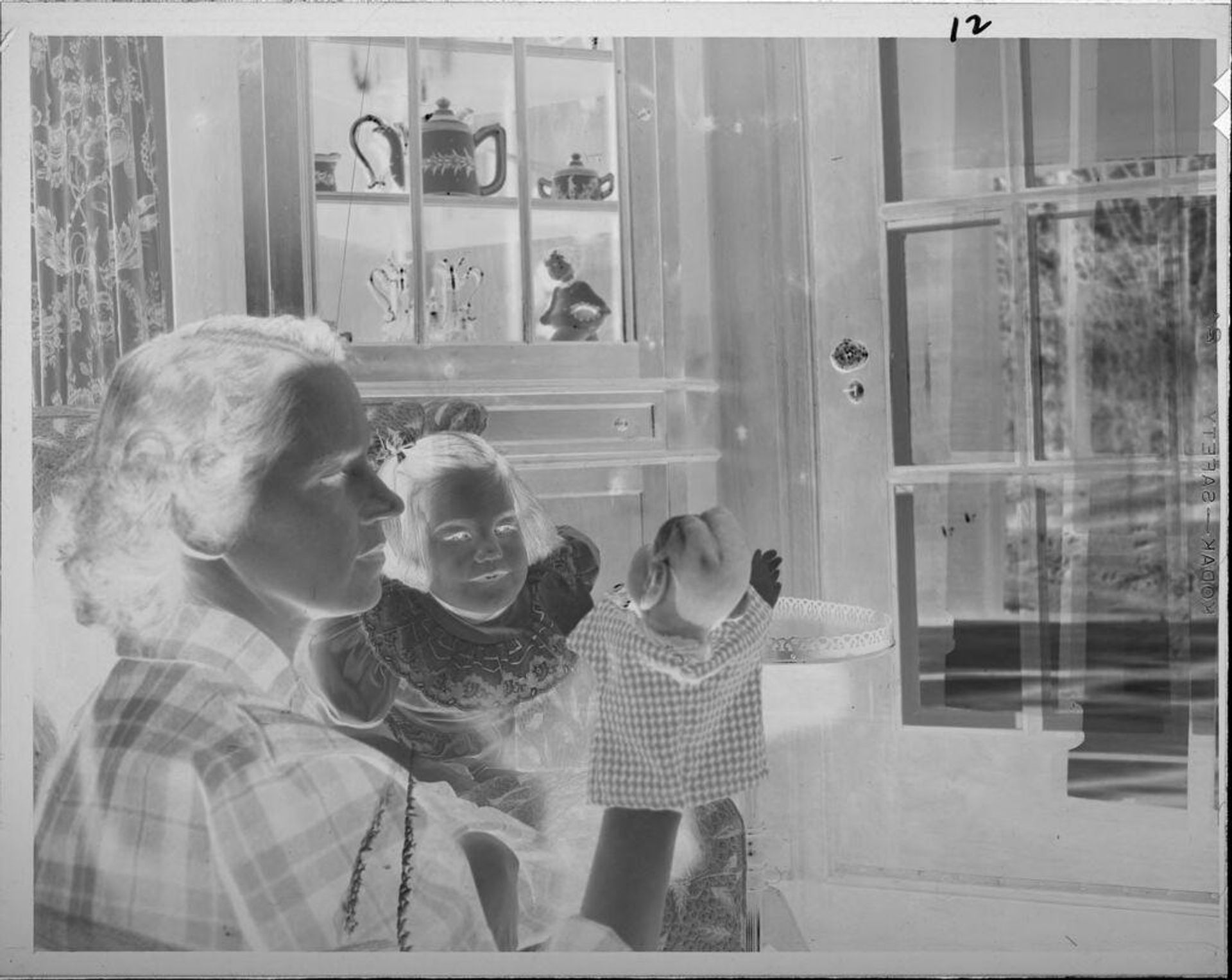 Untitled (woman showing puppet to little girl) by Lucian and Mary Brown