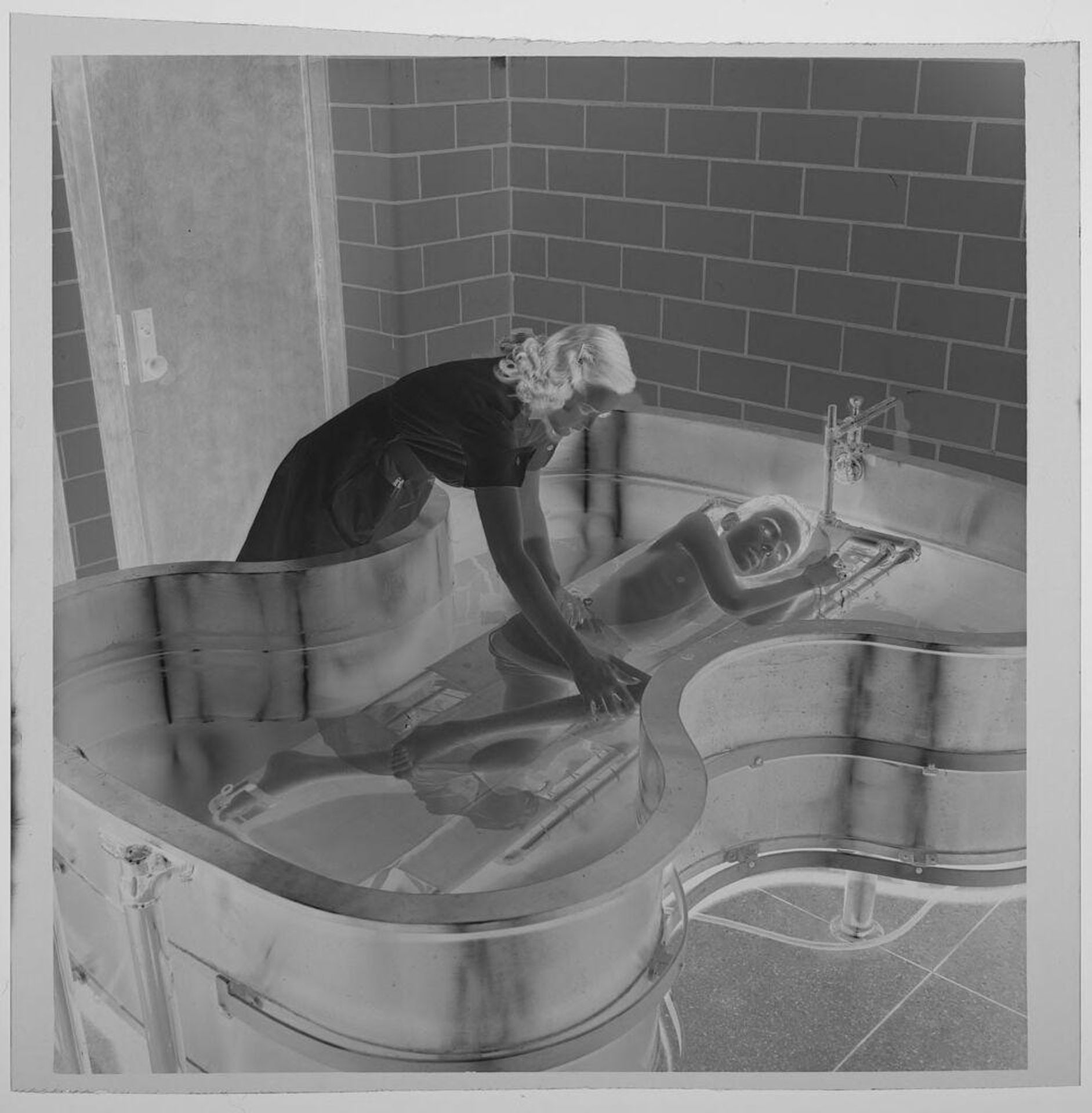 Untitled (child taking bath in therapeutic tub) by Jack Gould