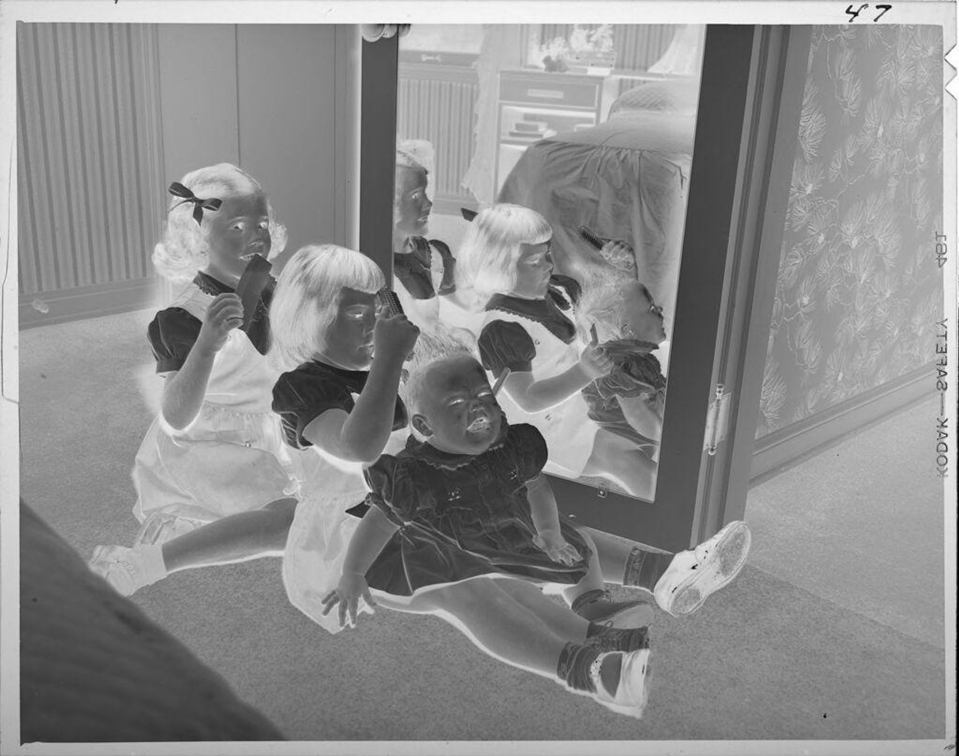 Untitled (two girls and baby combing hair) by Lucian and Mary Brown