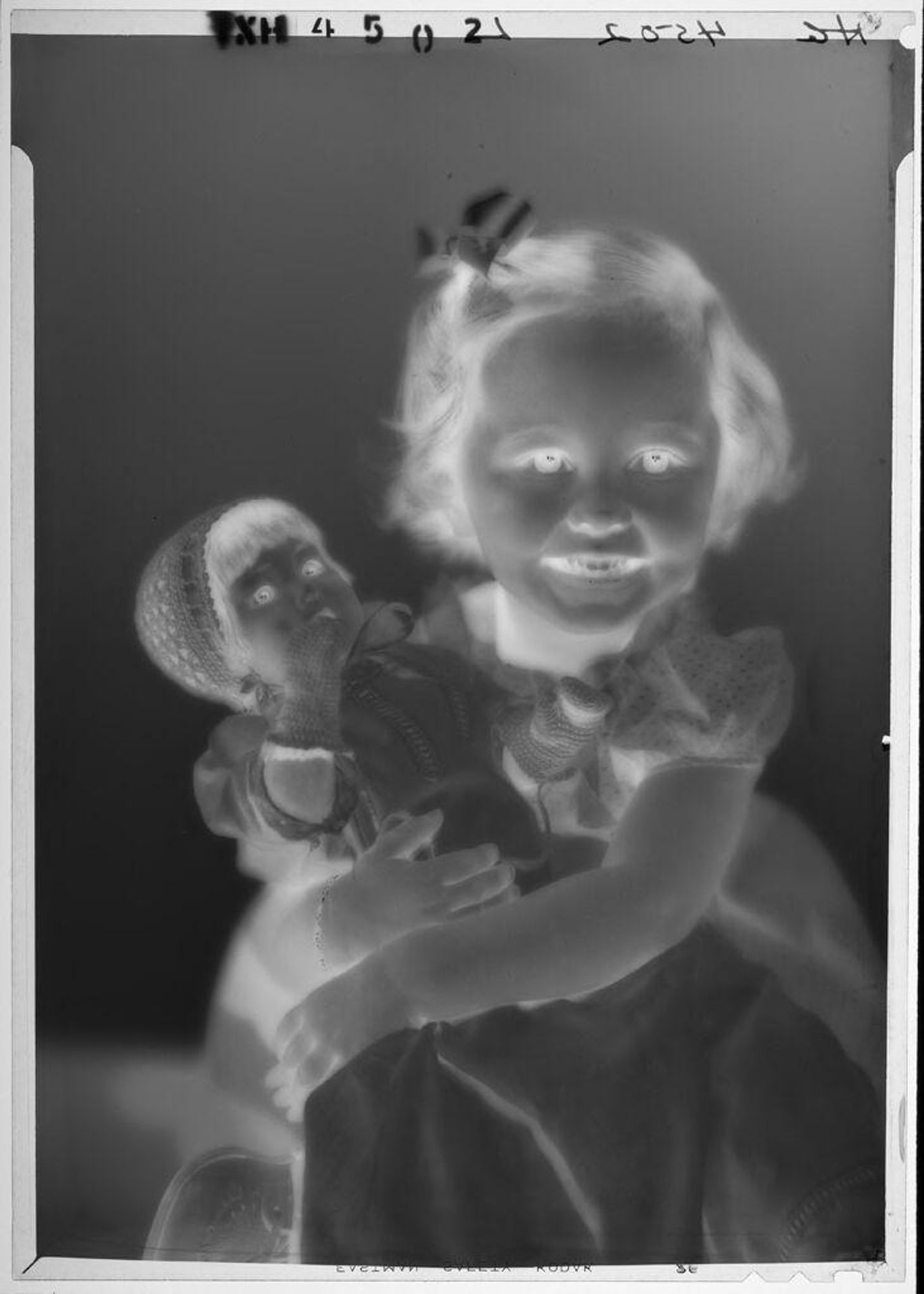 Untitled (portrait of little girl holding doll in arms) by Paul Gittings