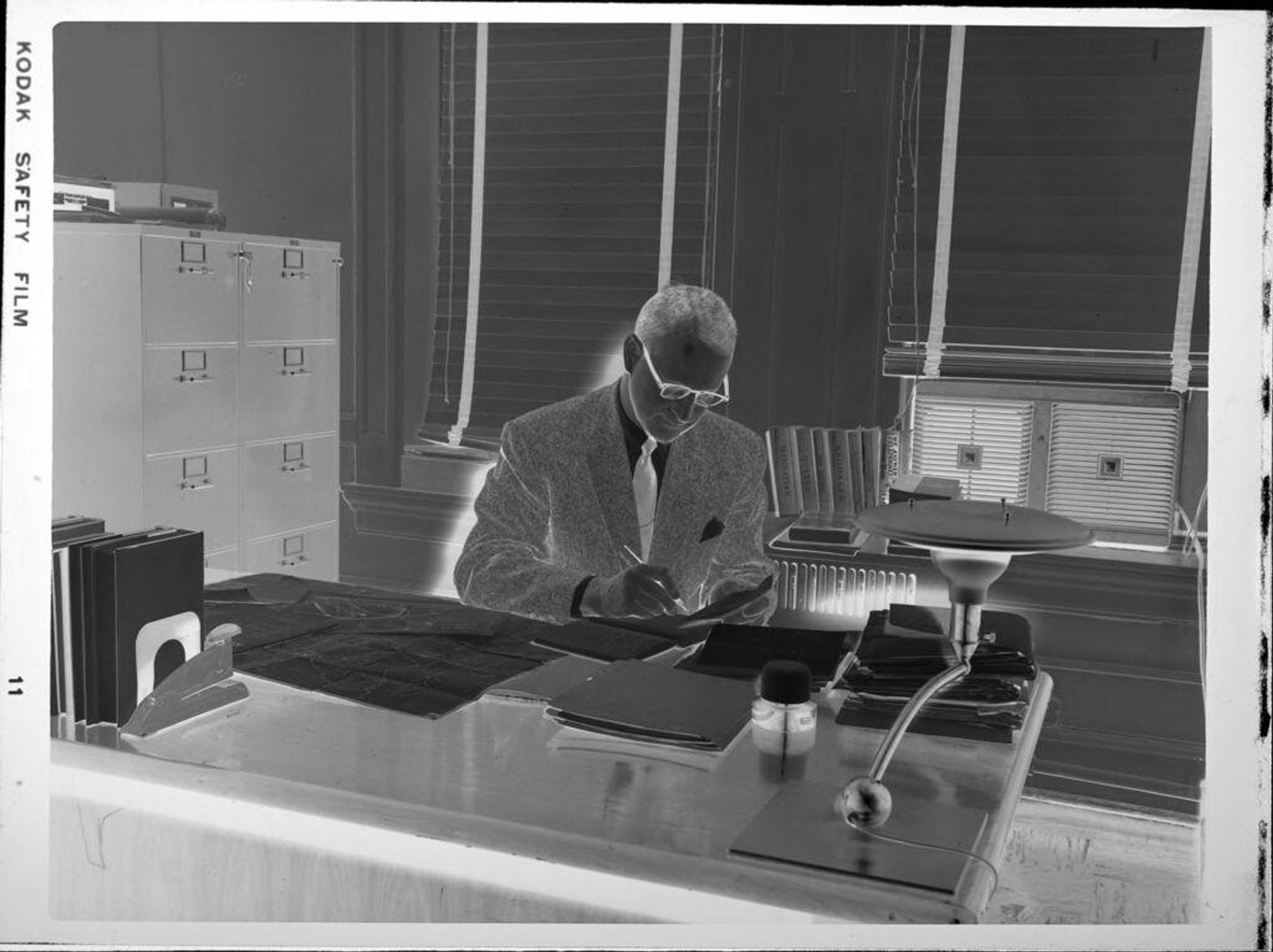 Untitled (man sitting at desk) by Peter James Studio
