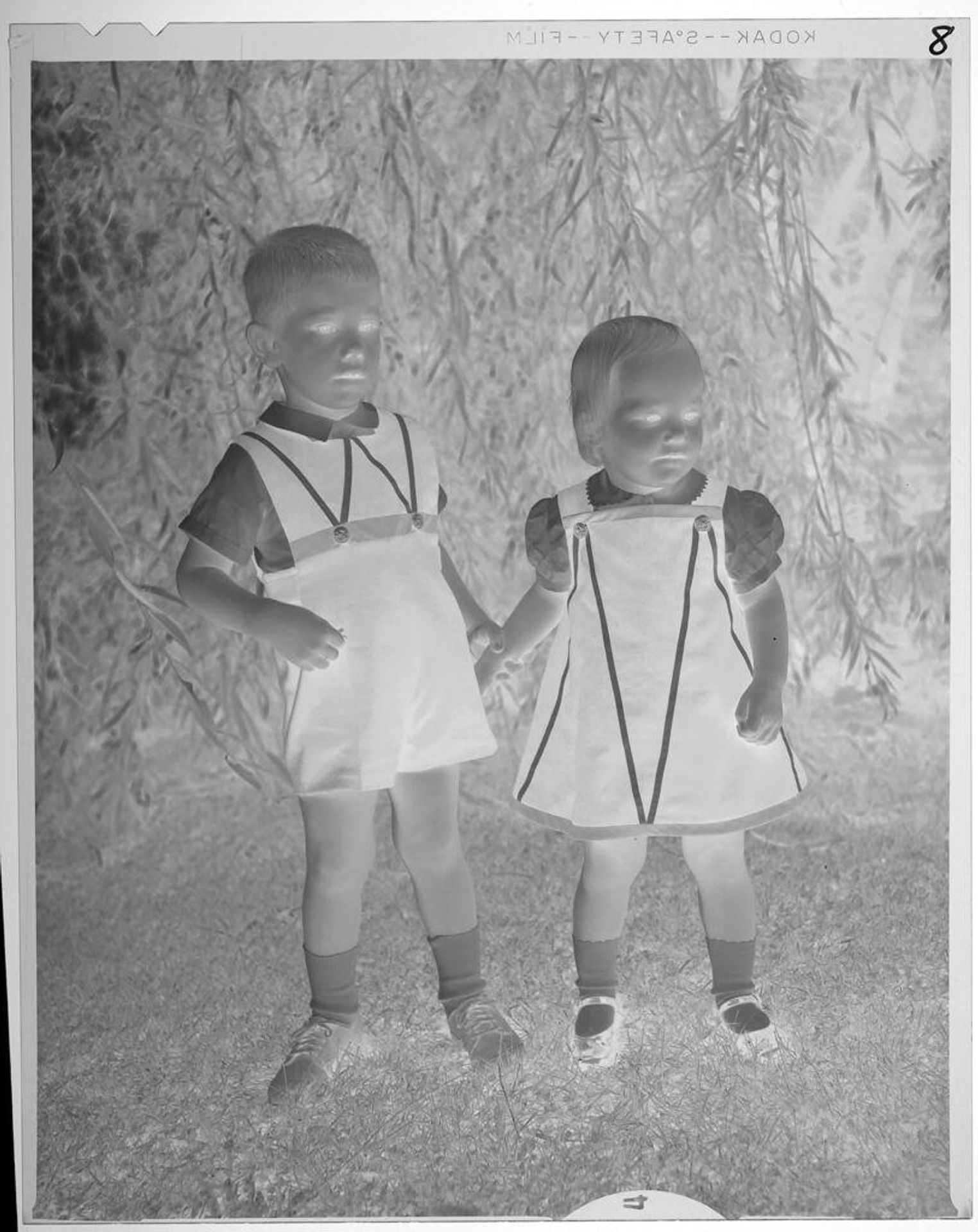 Untitled (little boy and girl in matching outfits posing outside) by Lucian and Mary Brown