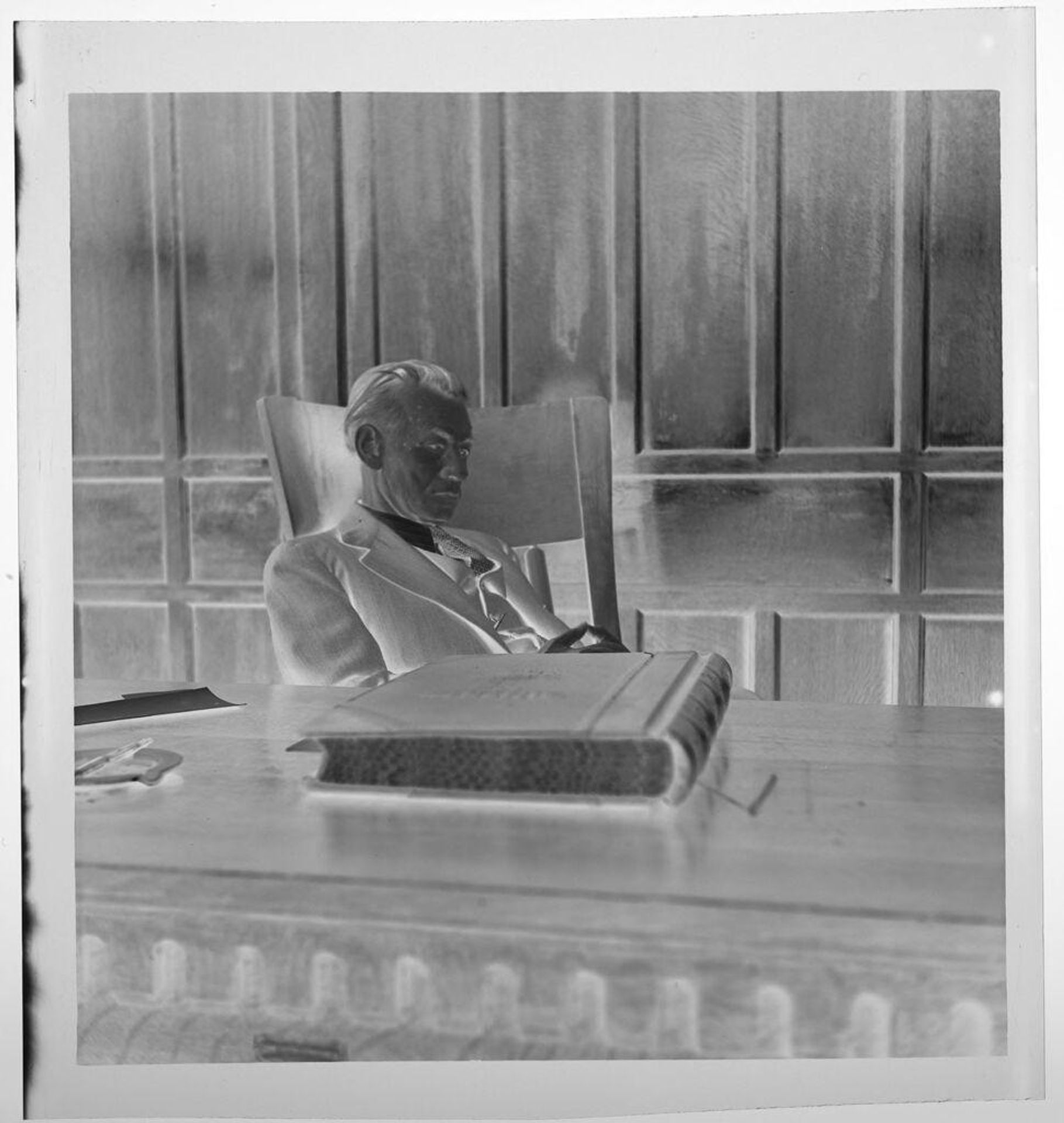 Untitled (judge sitting at his desk with large book in front) by Jack Gould