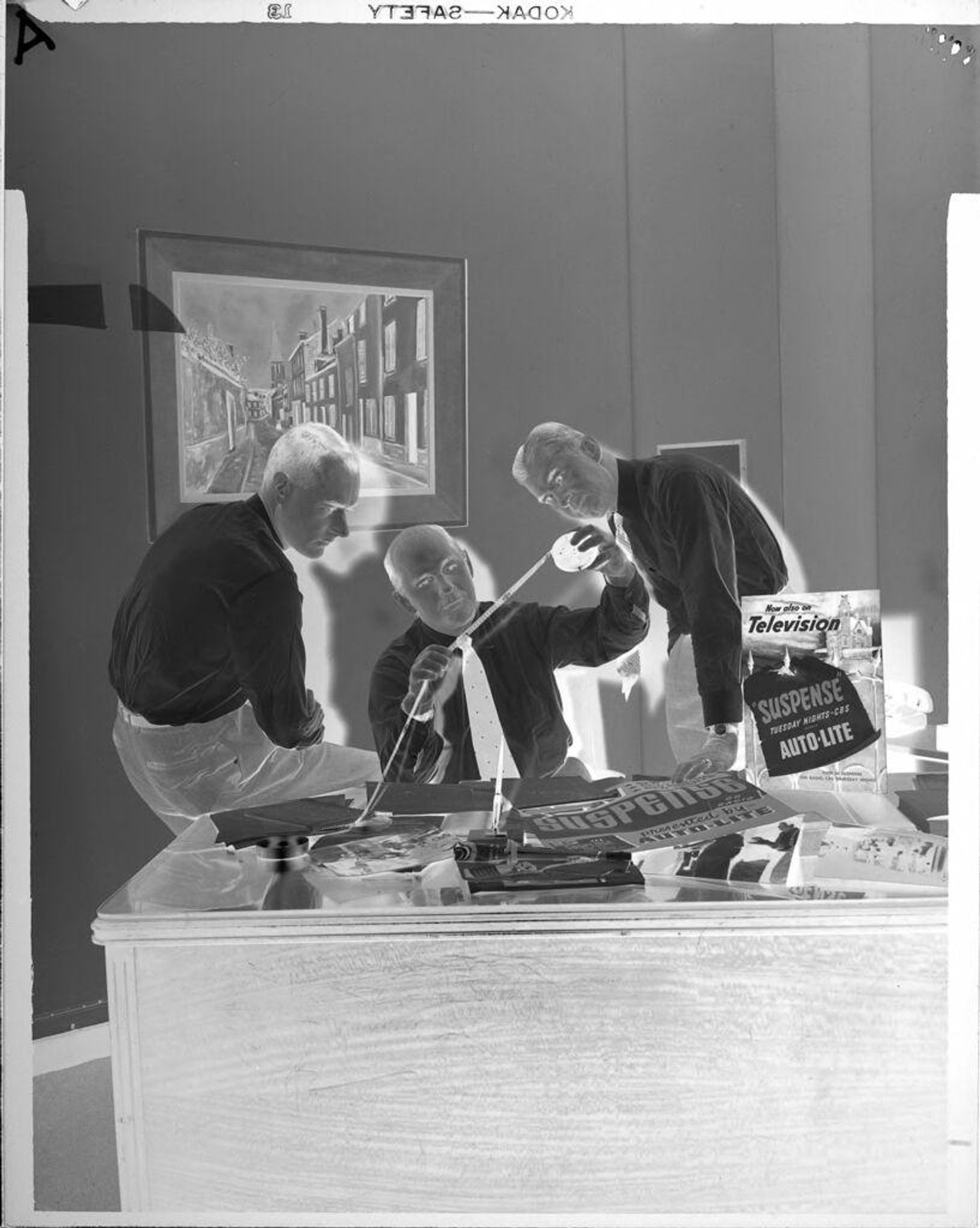 Untitled (three men at desk) by Peter James Studio
