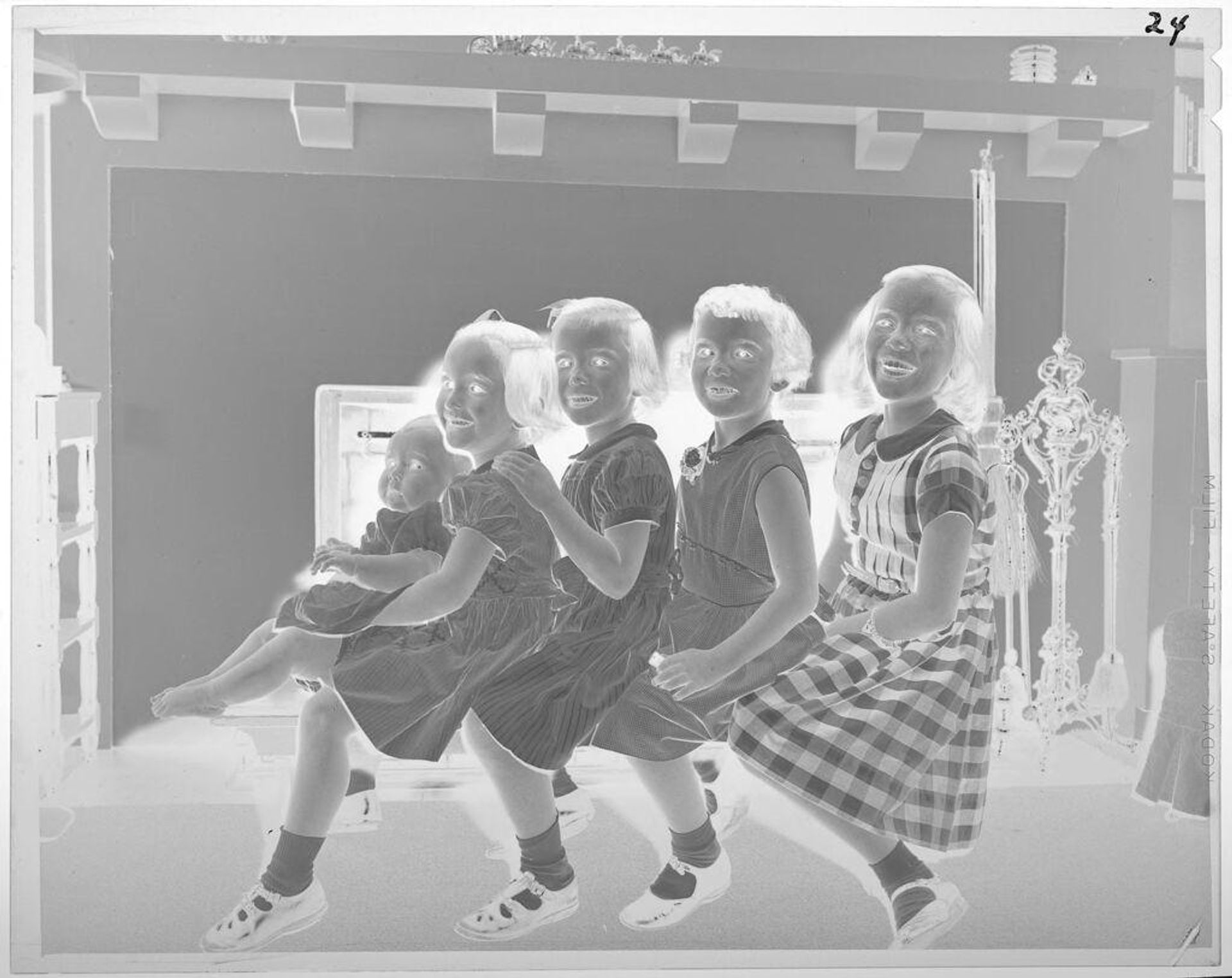 Untitled (four smiling girls and baby, all in a line) by Lucian and Mary Brown