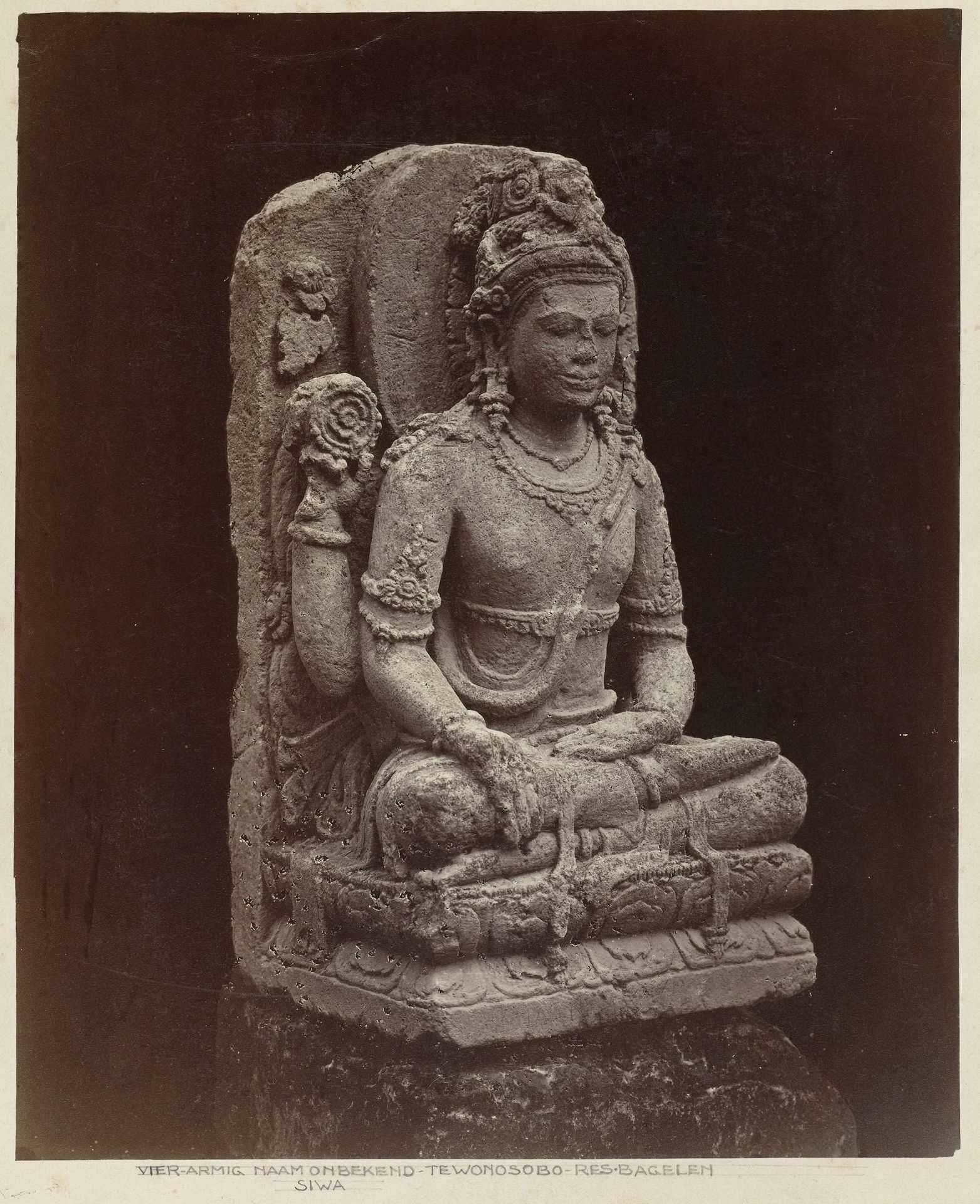Four-armed Shiva decorating the entrance way to the residedncy of the assistent-resident of Wonosobo (provenance Dieng Plateau) Wonosobo, Wonosobo district, Central Java province, 10the century. by Isidore Kinsbergen