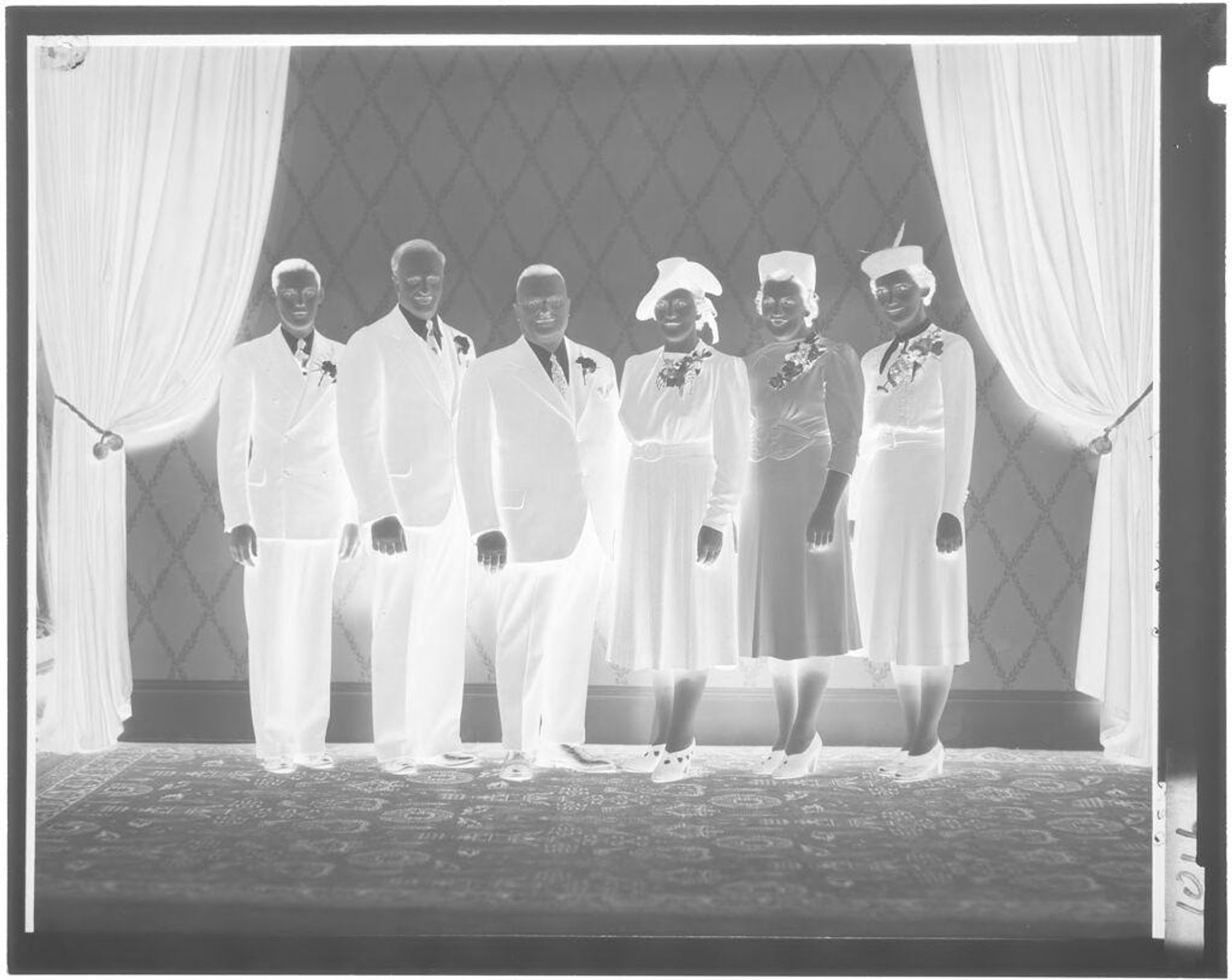Untitled (group portrait, standing between pulled back curtains) by John Deusing