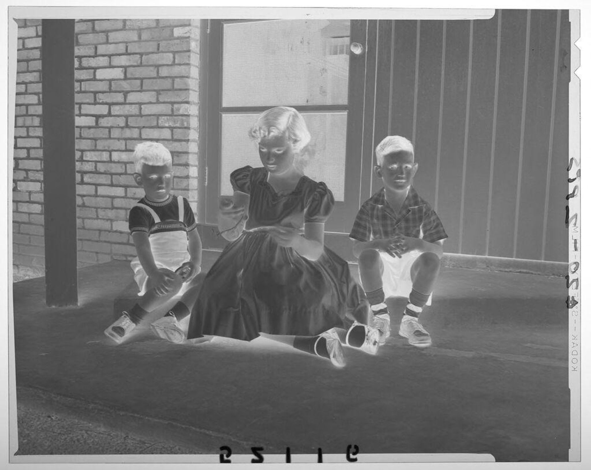 Untitled (girl and two boys sitting outside door of house) by Martin Schweig