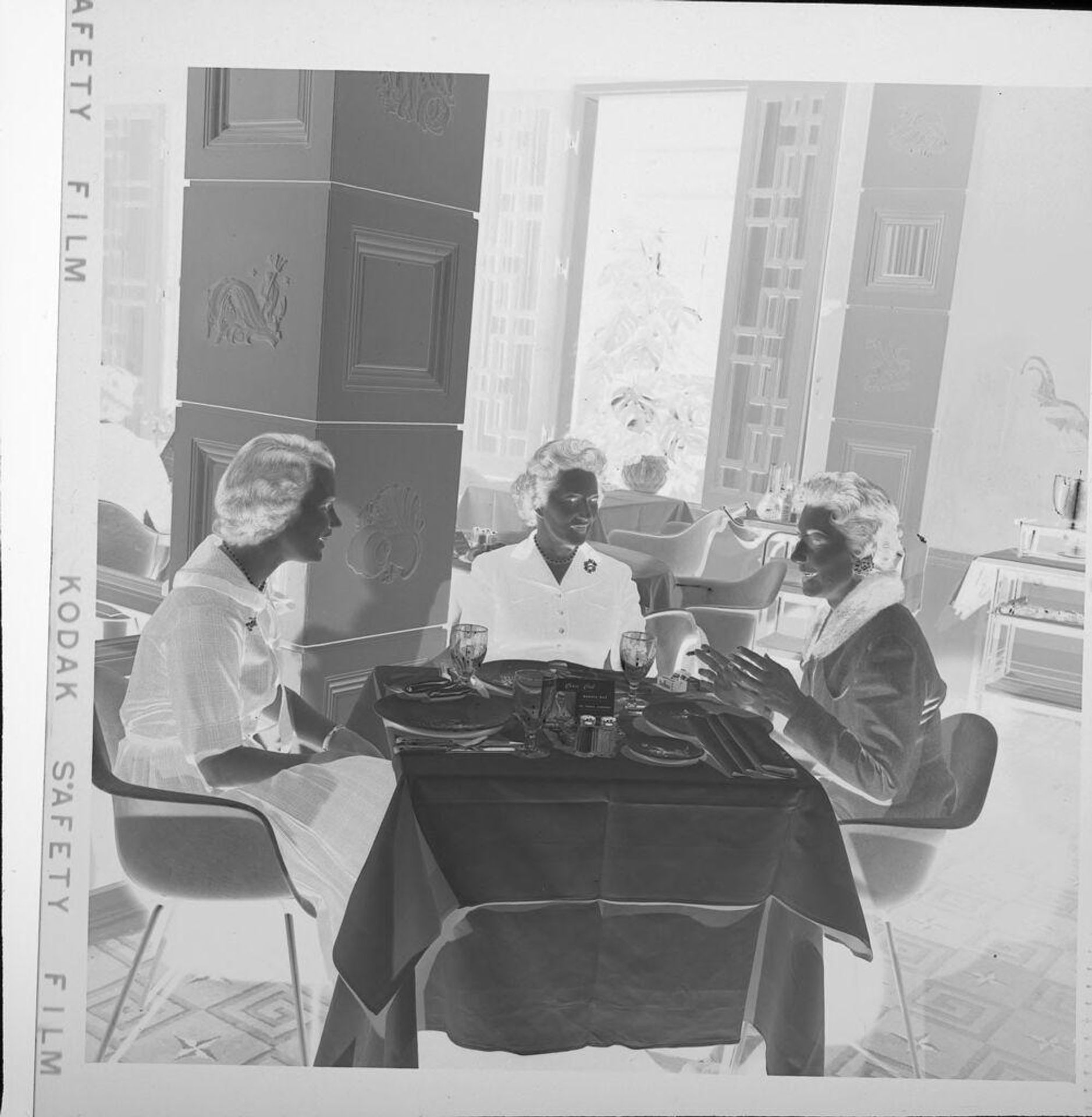 Untitled (three women sitting at table) by Jack Gould