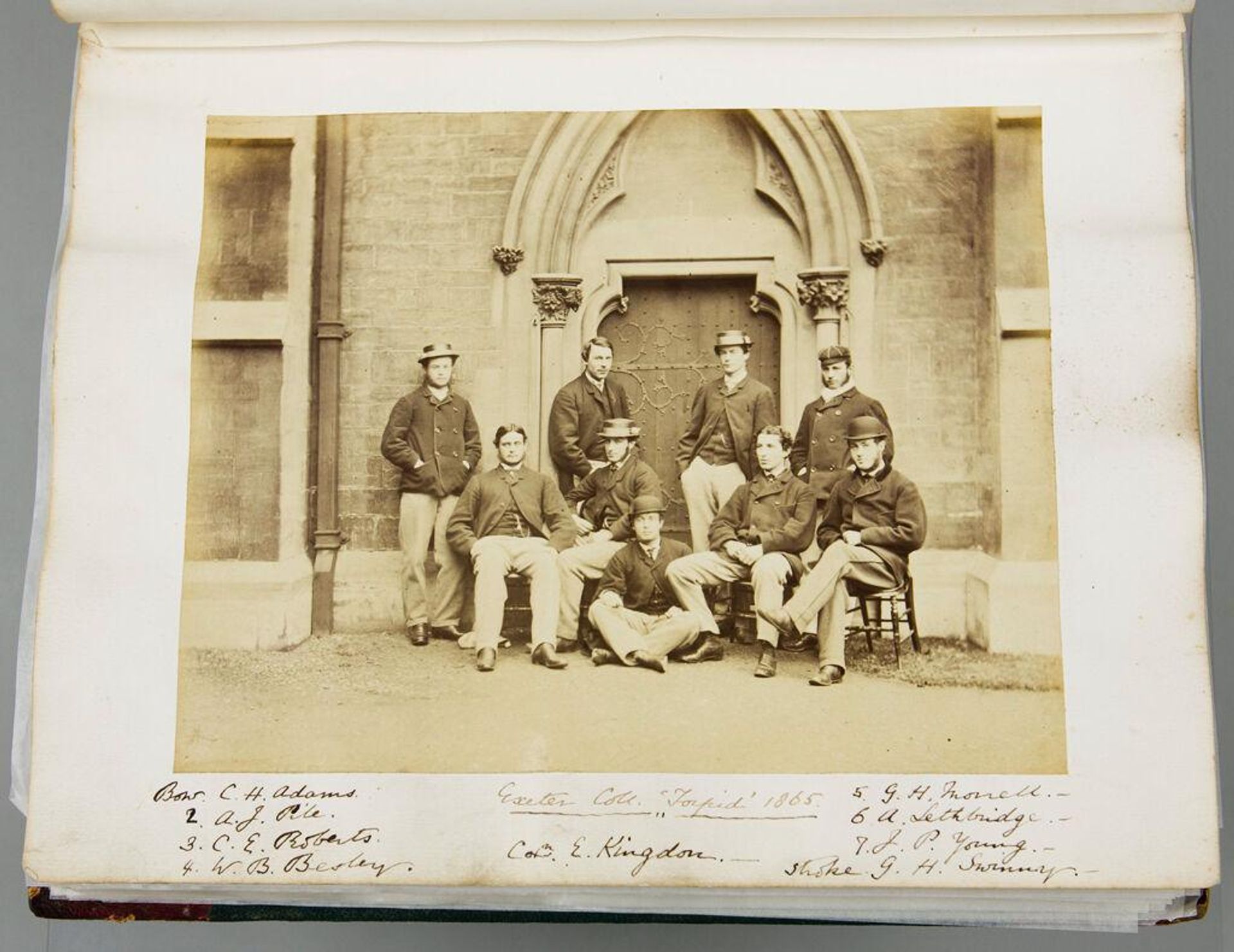 Untitled (Group portrait of Exeter College "Torpid" (rowing team) 1865. Bow. C. H. Adams; 2. A. J. Pile; 3. C. E. Roberts; 4. W. B. Besley; 5. G. H. Morrell; 6. A. Lethbridge; 7. J. P. Young; Stroke, G. H. Swinny; Coxman, E. Kingdon; verso: Photo montage labeled "Exeter College Turl Street Front") by Iorwerth Grey Lloyd