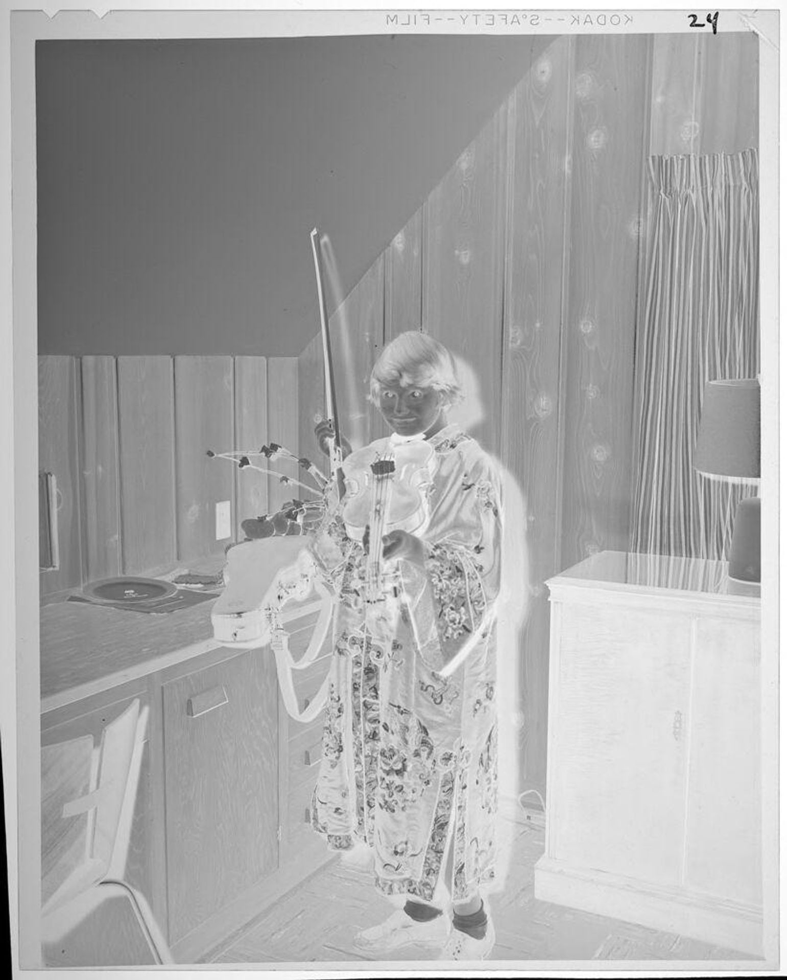 Untitled (girl in kimono playing violin) by Lucian and Mary Brown