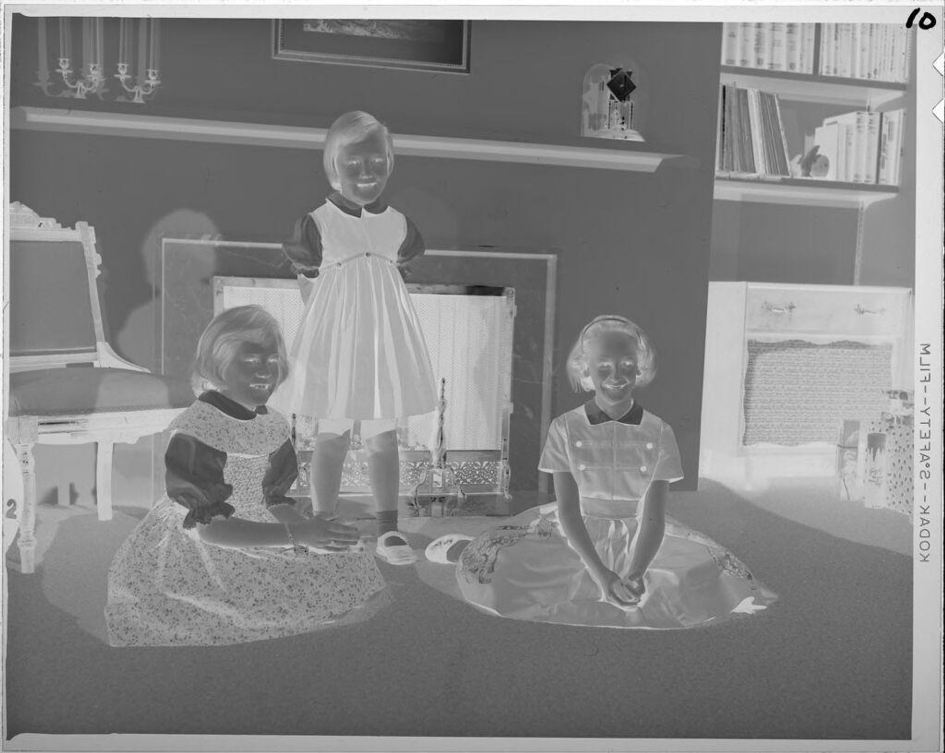 Untitled (three girls in front of fireplace) by Lucian and Mary Brown
