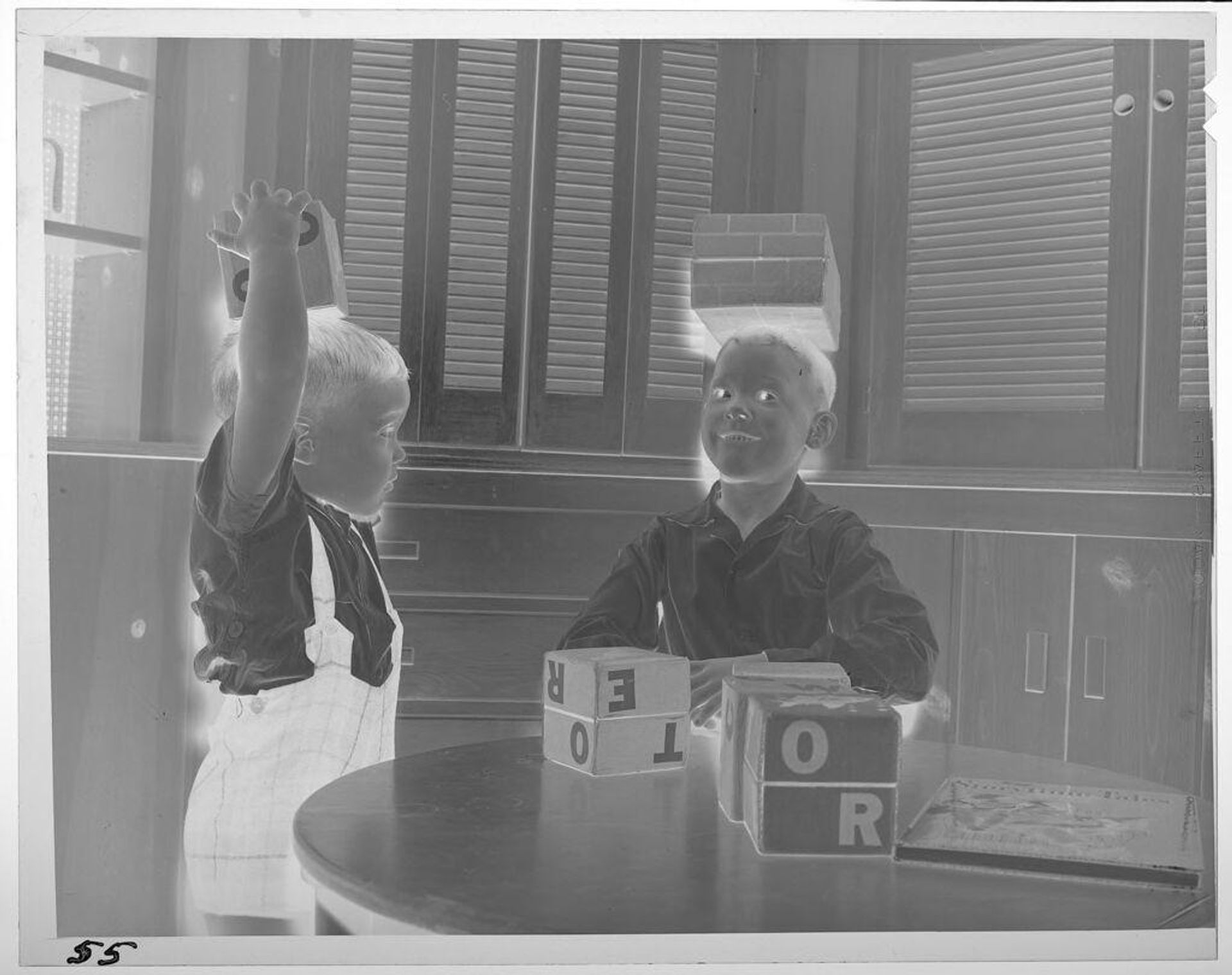 Untitled (boys playing with blocks, placing blocks on heads) by Lucian and Mary Brown