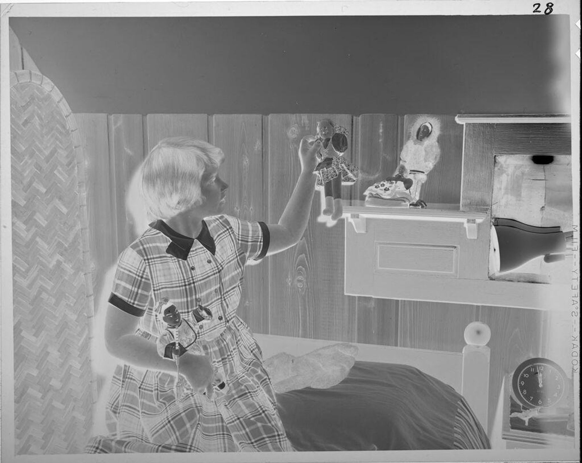 Untitled (girl playing with dolls) by Lucian and Mary Brown