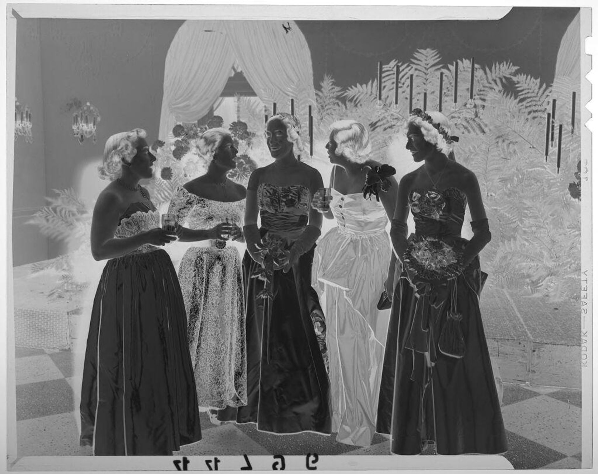 Untitled (five young women in formal wear posed chatting at fancy event) by Martin Schweig