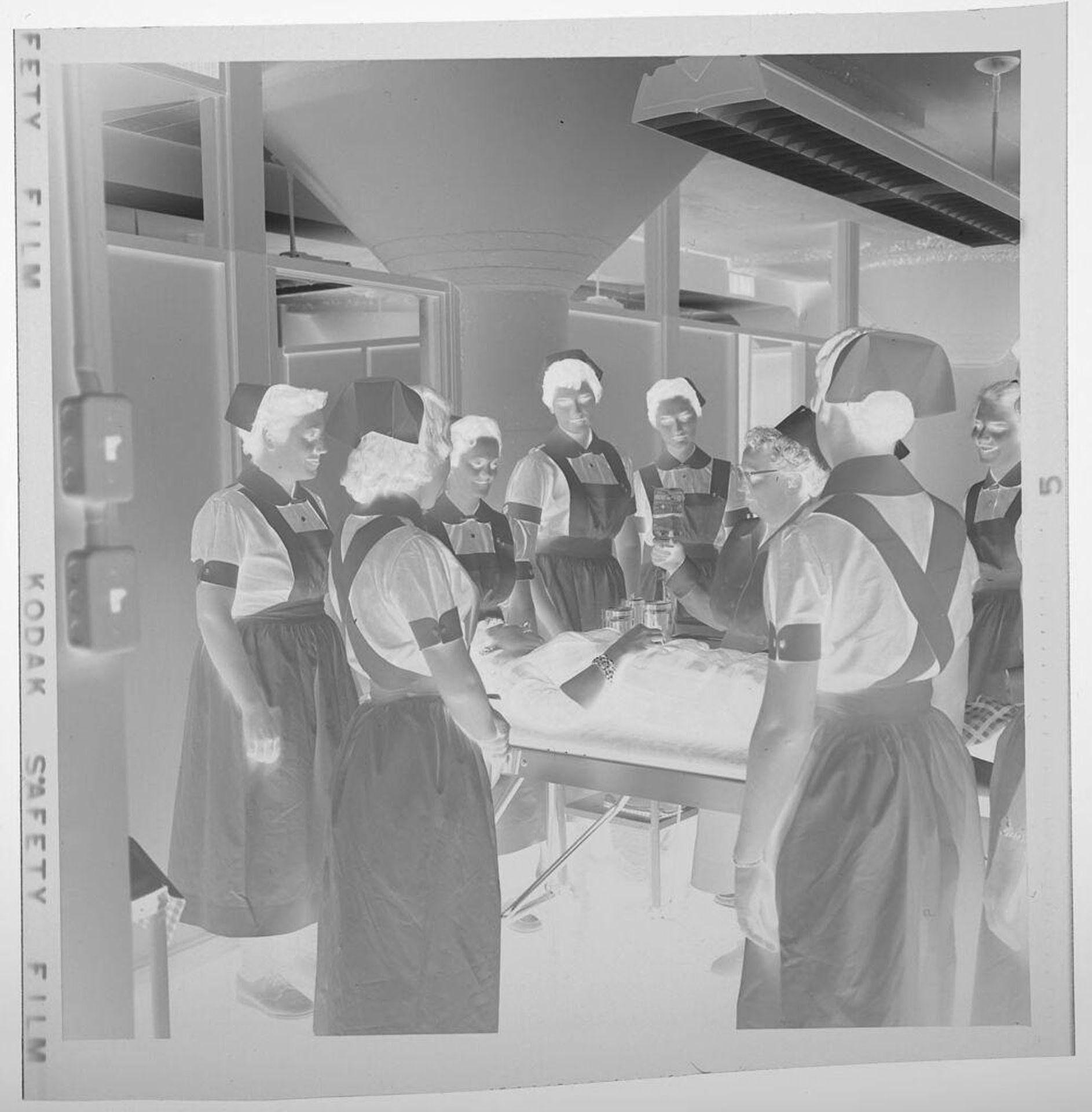 Untitled (nurses gathered around hospital bed) by Jack Gould