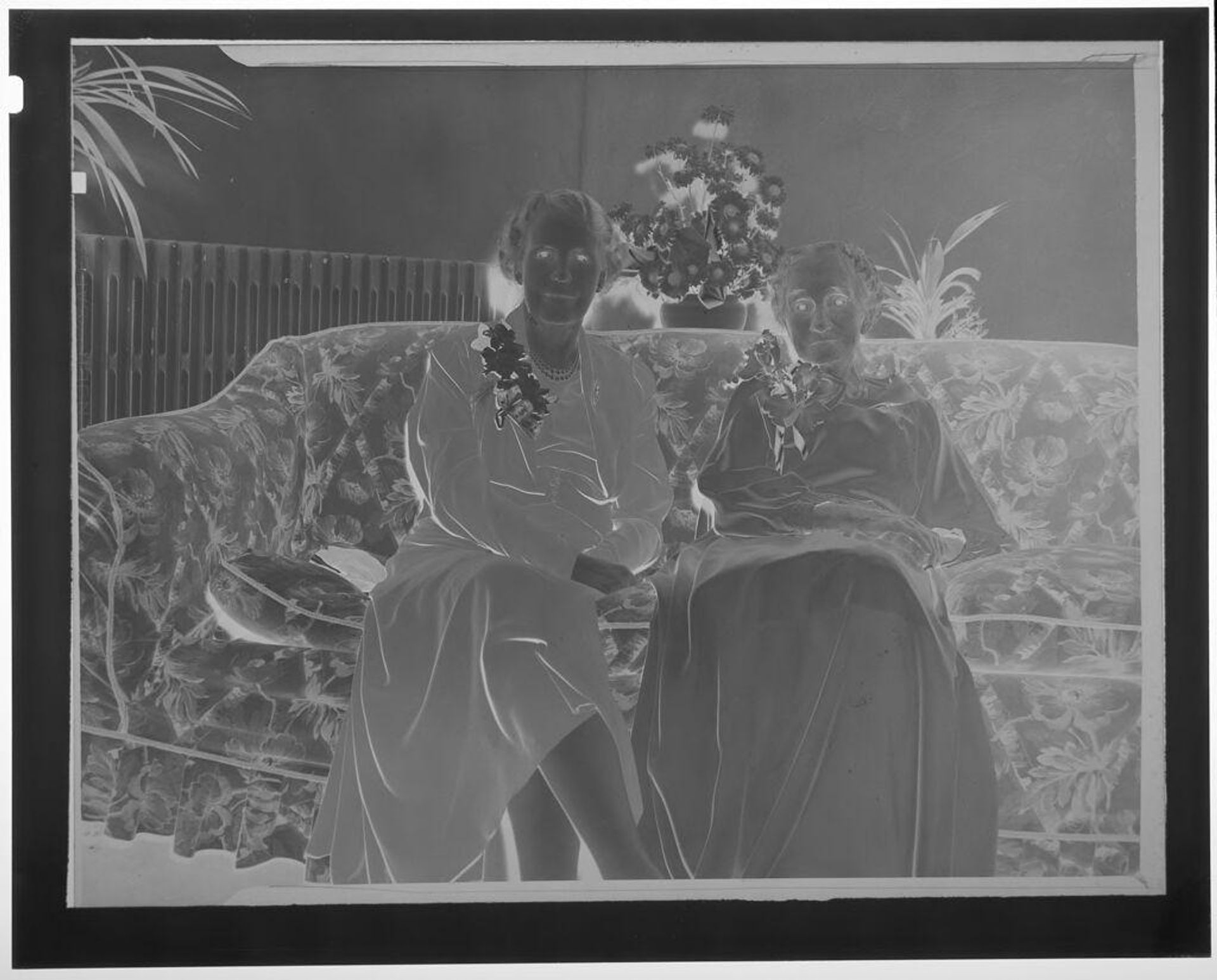 Untitled (old woman and middle-aged woman seated in couch wearing dresses and corsages) by Martin Schweig