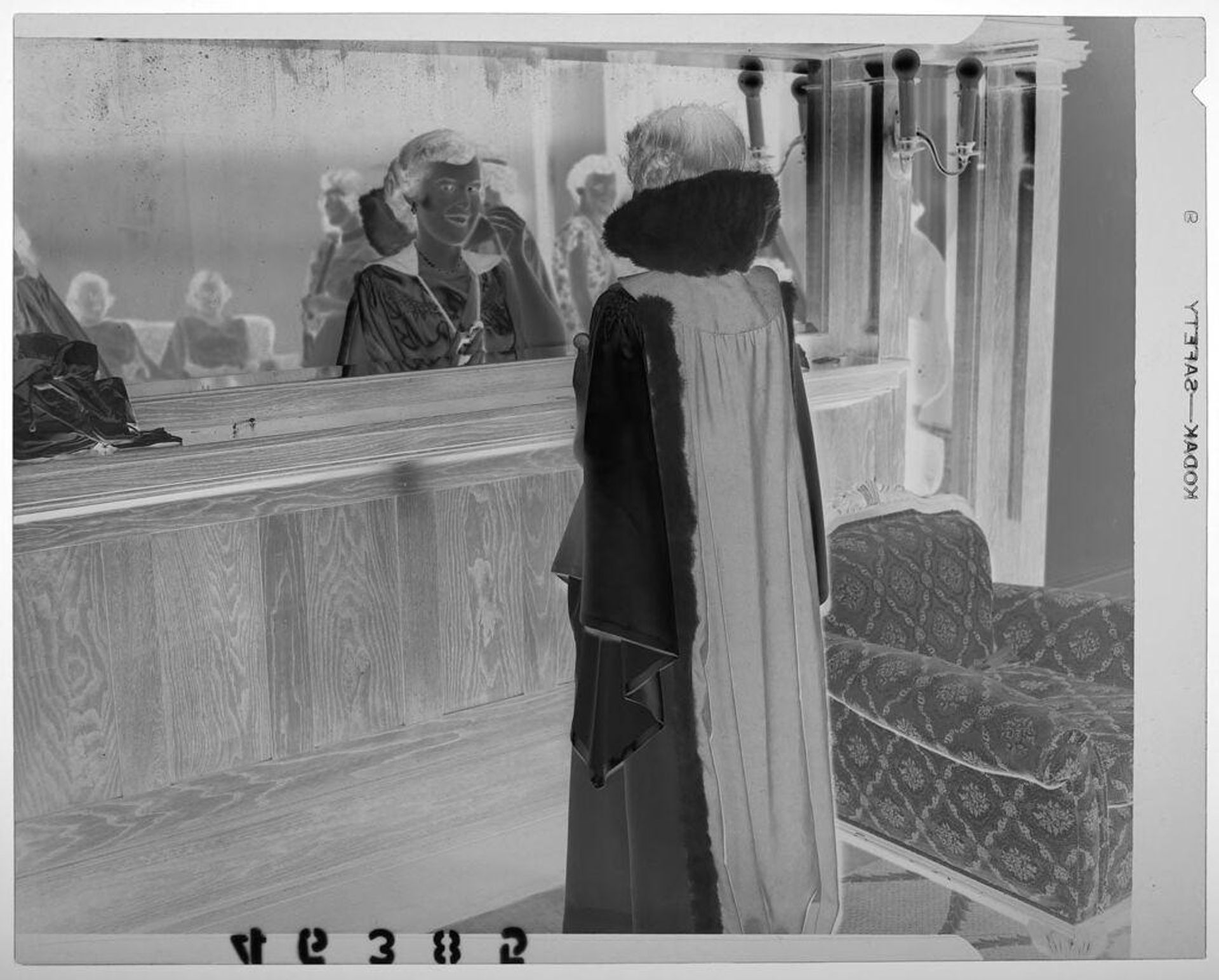 Untitled (woman in Masonic robes posed looking in mirror reflecting other young women) by Martin Schweig