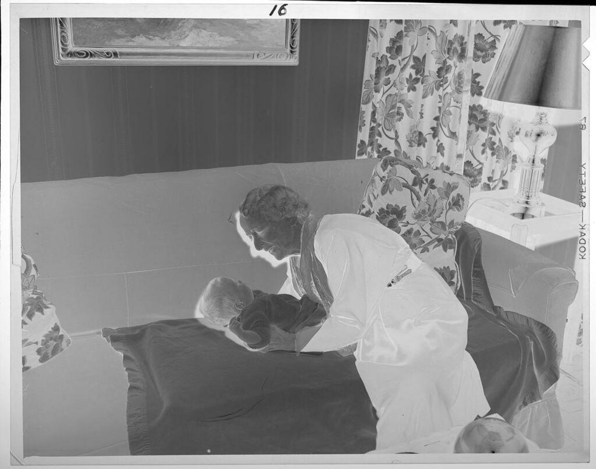 Untitled (elderly woman holding baby on couch) by Lucian and Mary Brown
