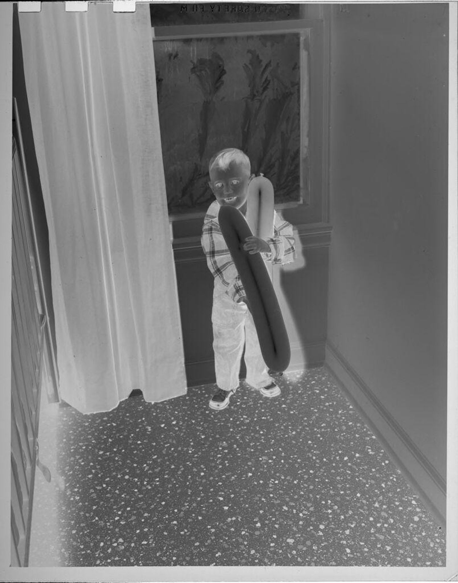 Untitled (boy holding balloons) by Lucian and Mary Brown