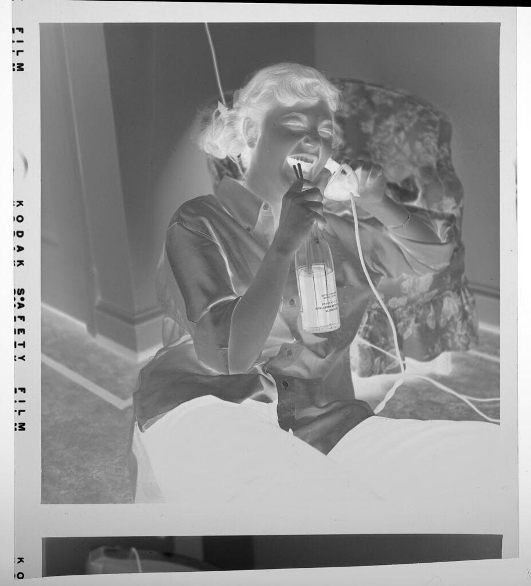 Untitled (laughing girl talking on telephone) by Jack Gould
