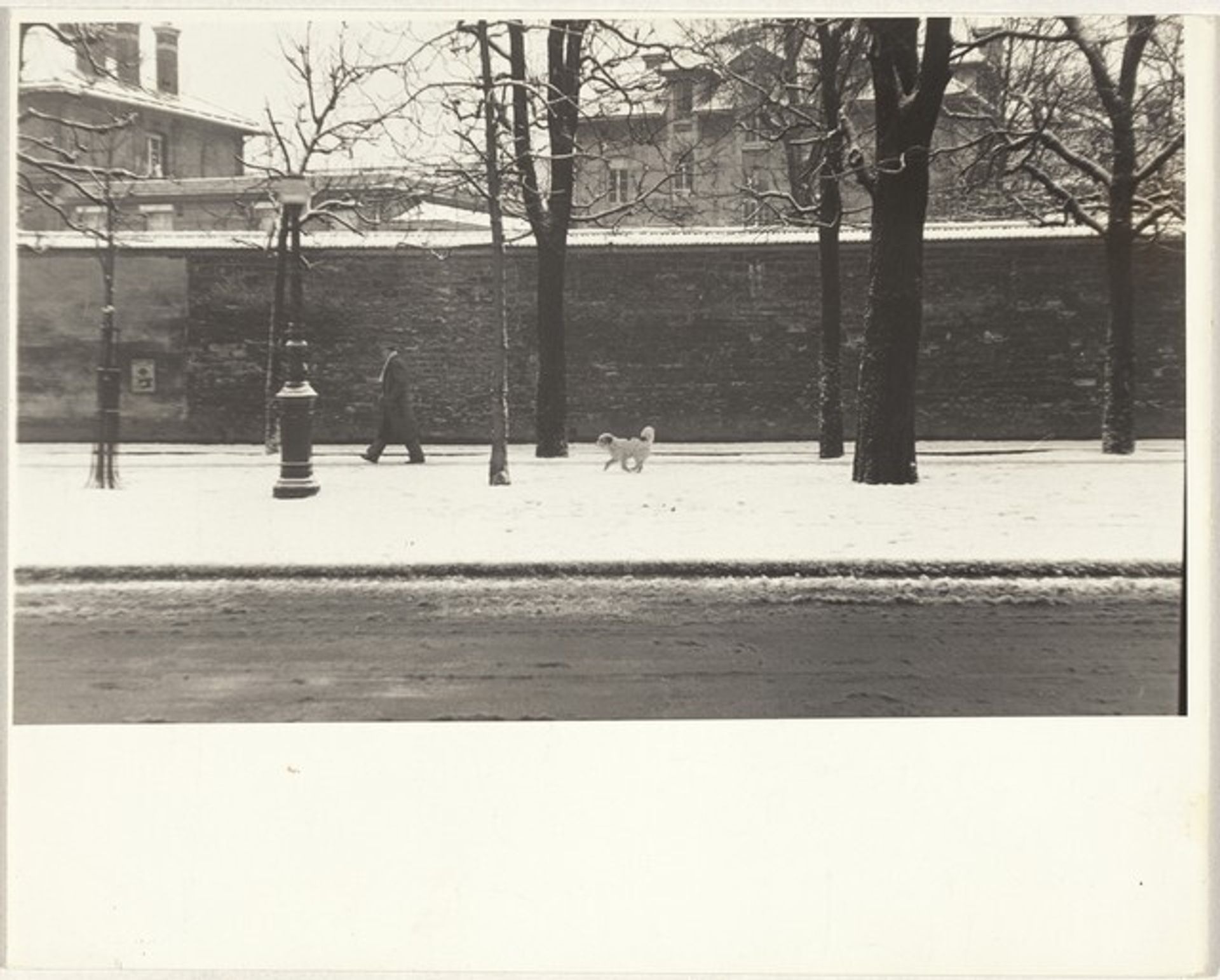 Man walking dog in snow, Paris by Robert Frank