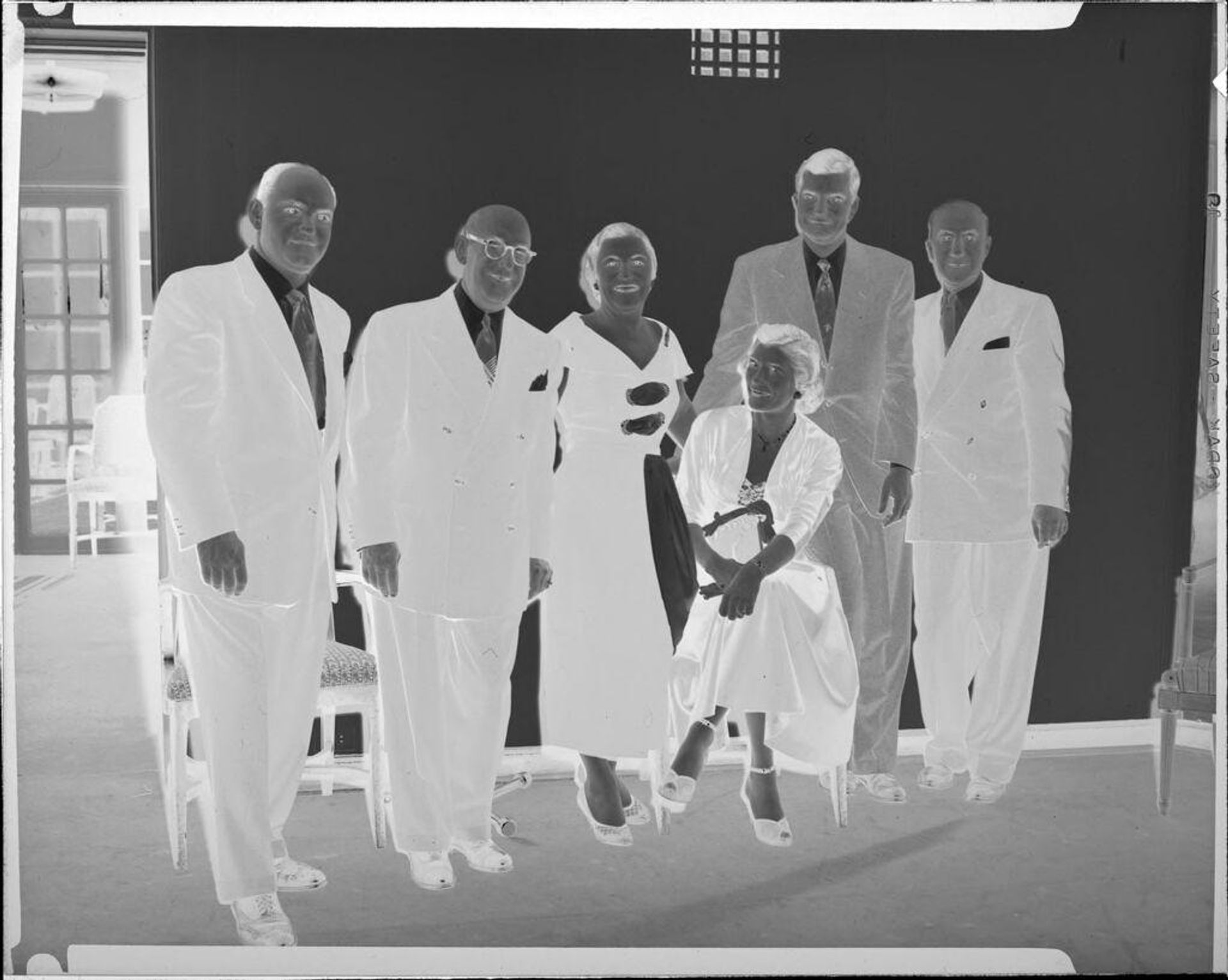 Untitled (four men and two women at party) by Peter James Studio