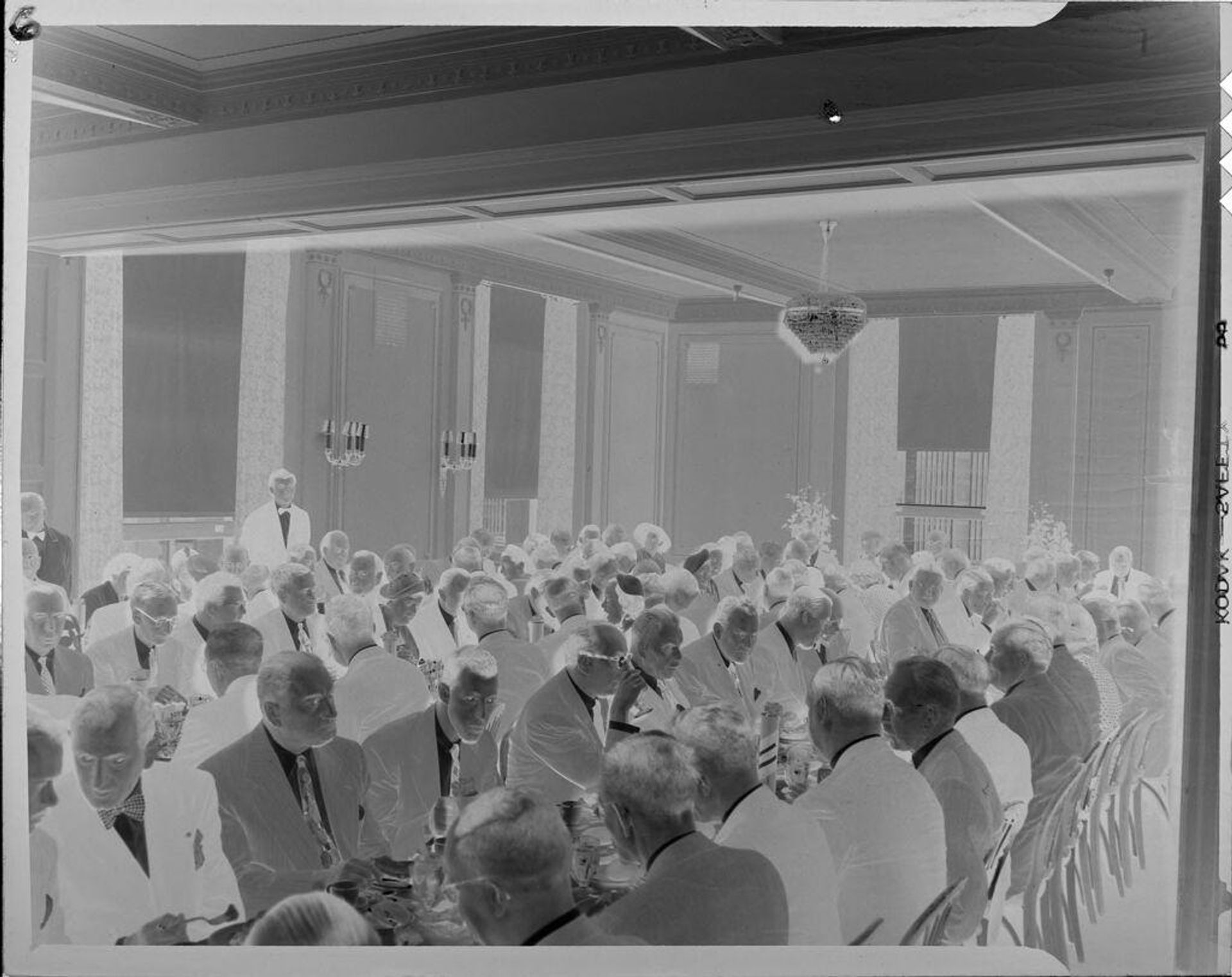 Untitled (long tables of guests at banquet) by Peter James Studio
