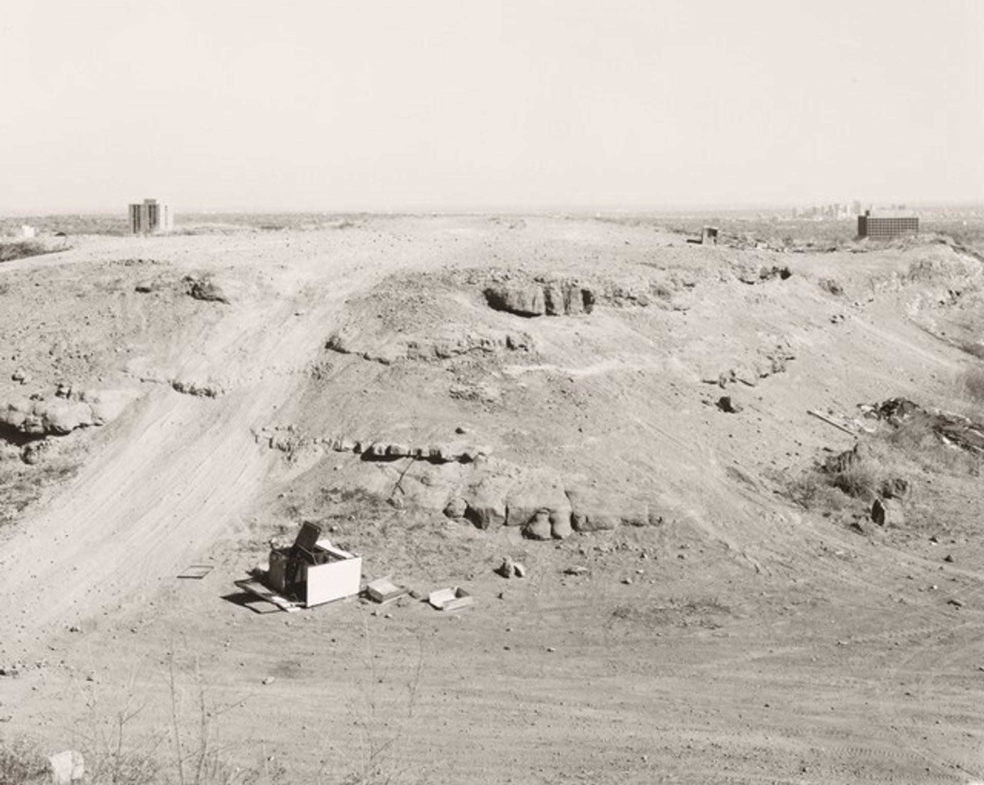 Table lands worn by recreational vehicles; Denver at right by Robert Adams