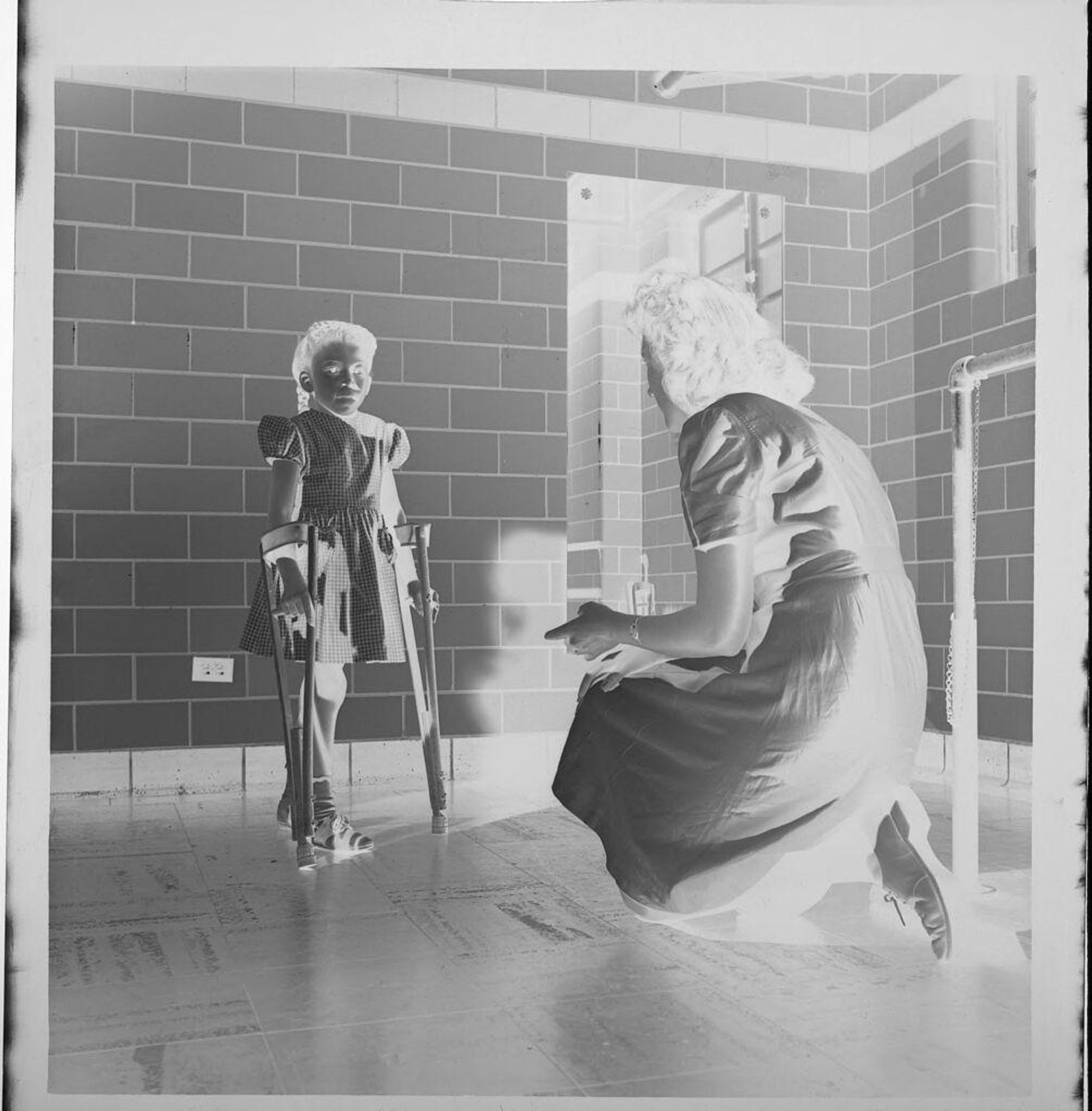 Untitled (child on crutches with nurse) by Jack Gould