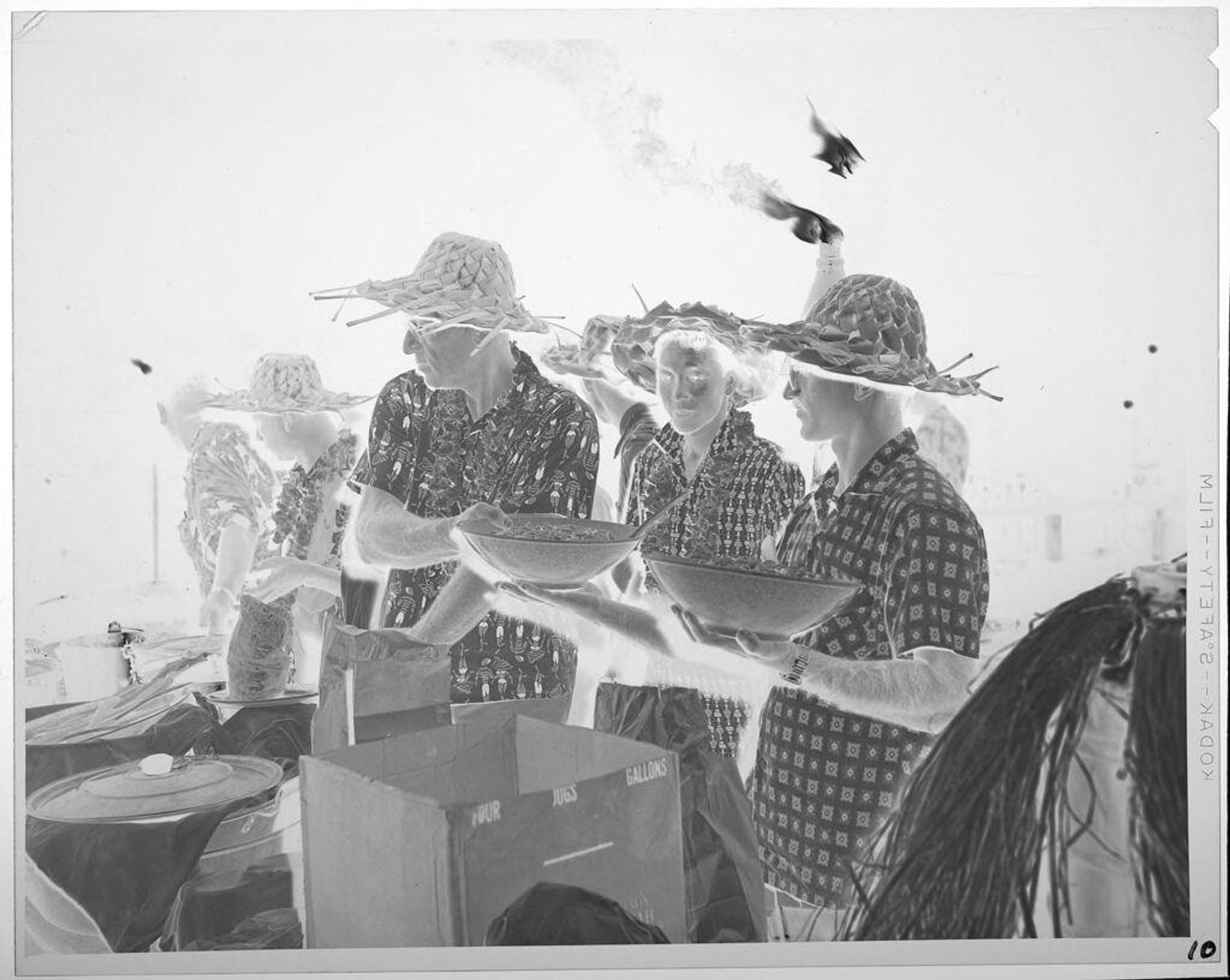 Untitled (people serving food at Luau) by Lucian and Mary Brown