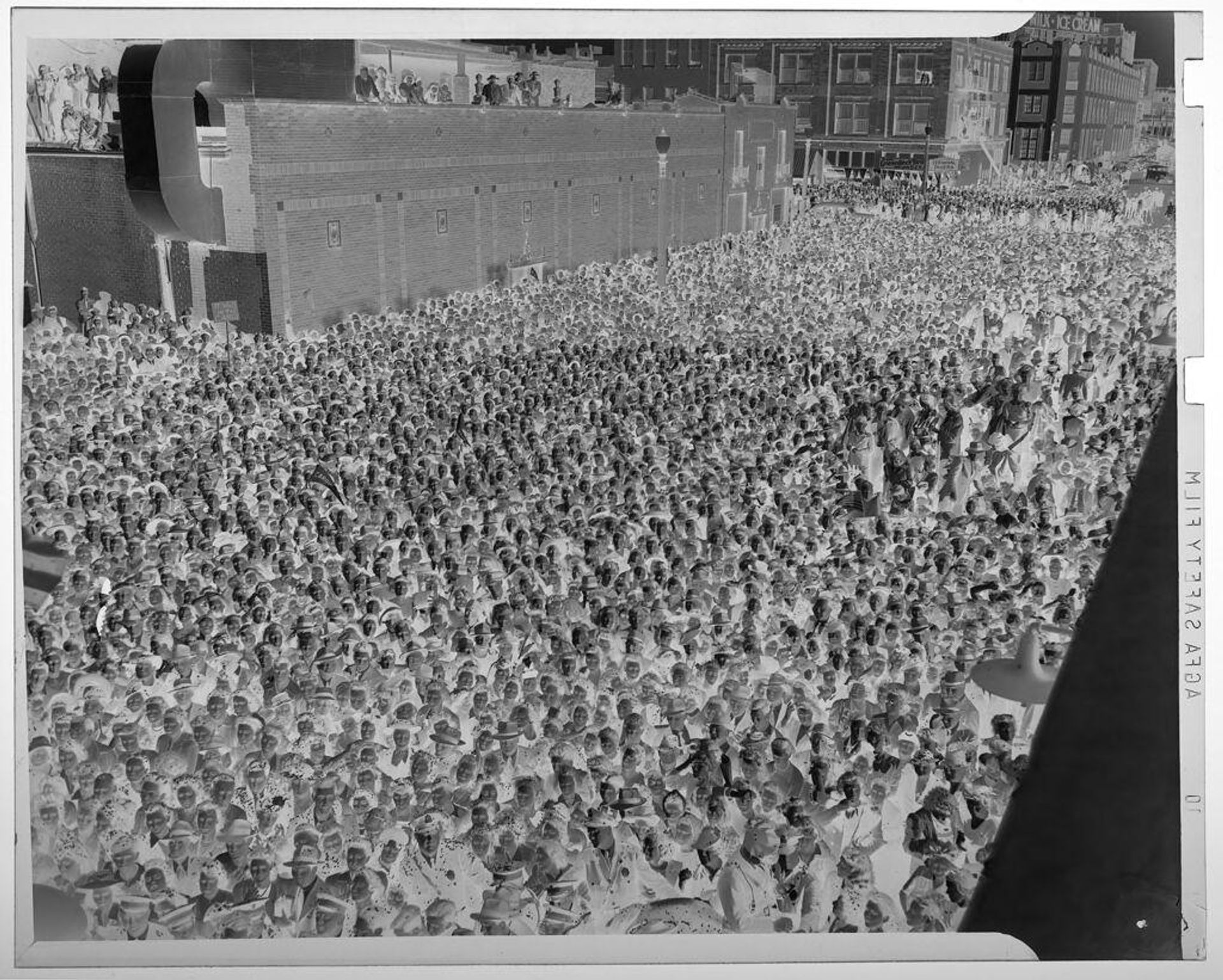 Untitled (enormous crowd of people on city street, seen from above) by Jack Gould