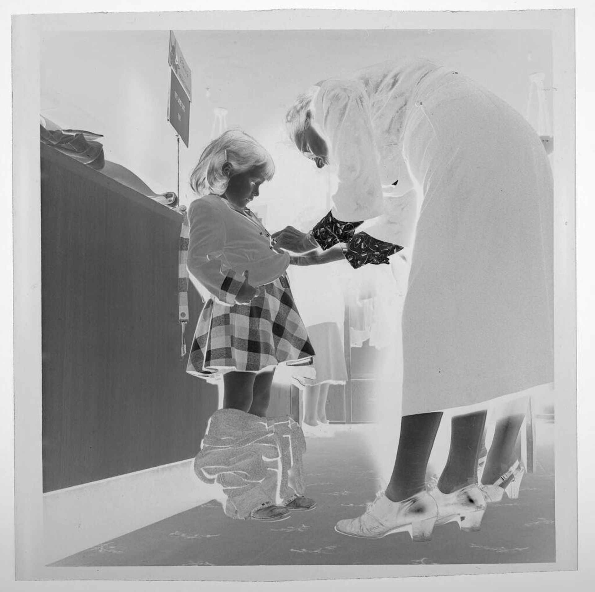Untitled (child trying on clothes in store) by Jack Gould