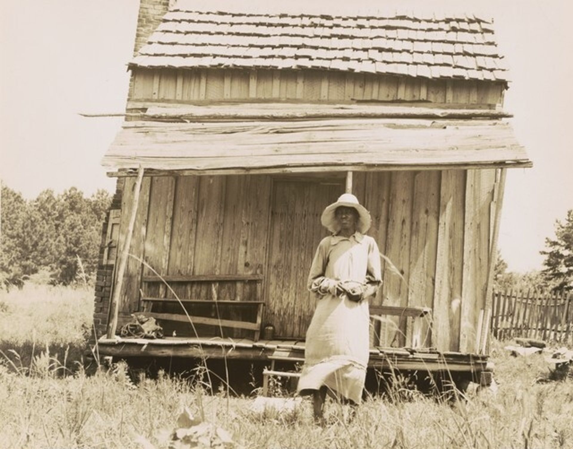 Sharecropper's cabin and sharecropper's wife, 10 miles south of Jackson, Mississippi by Dorothea Lange