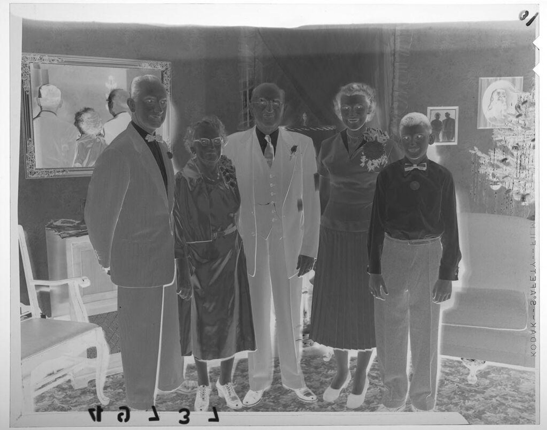 Untitled (five members of family posed together in room decorated for Christmas) by Martin Schweig