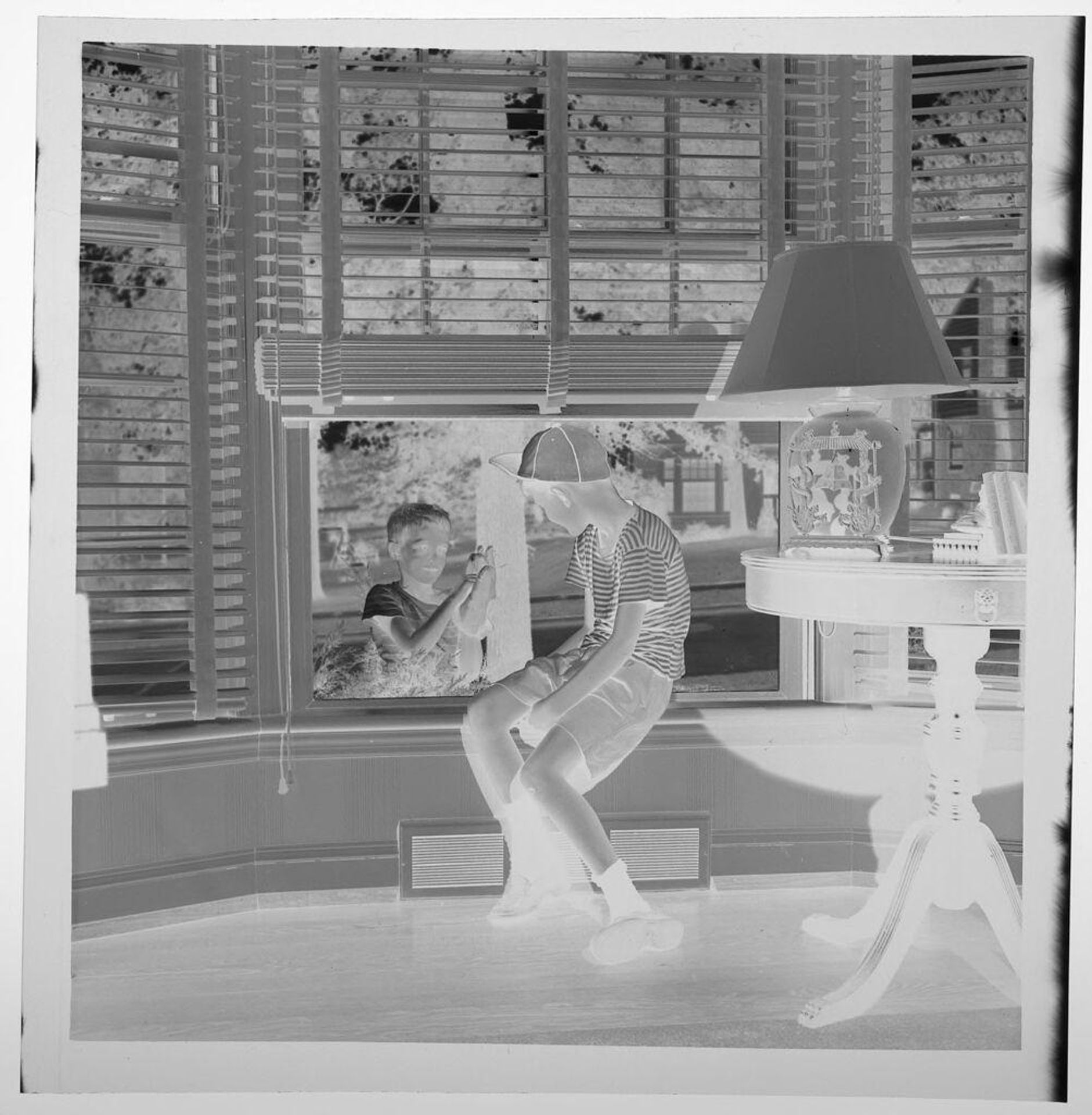 Untitled (boy looking out window at another boy looking in) by Jack Gould