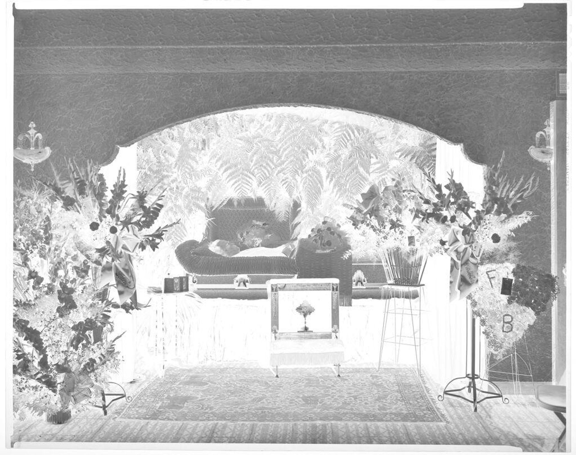 Untitled (portrait of a decease man, view of entire room in funeral home) by John Deusing