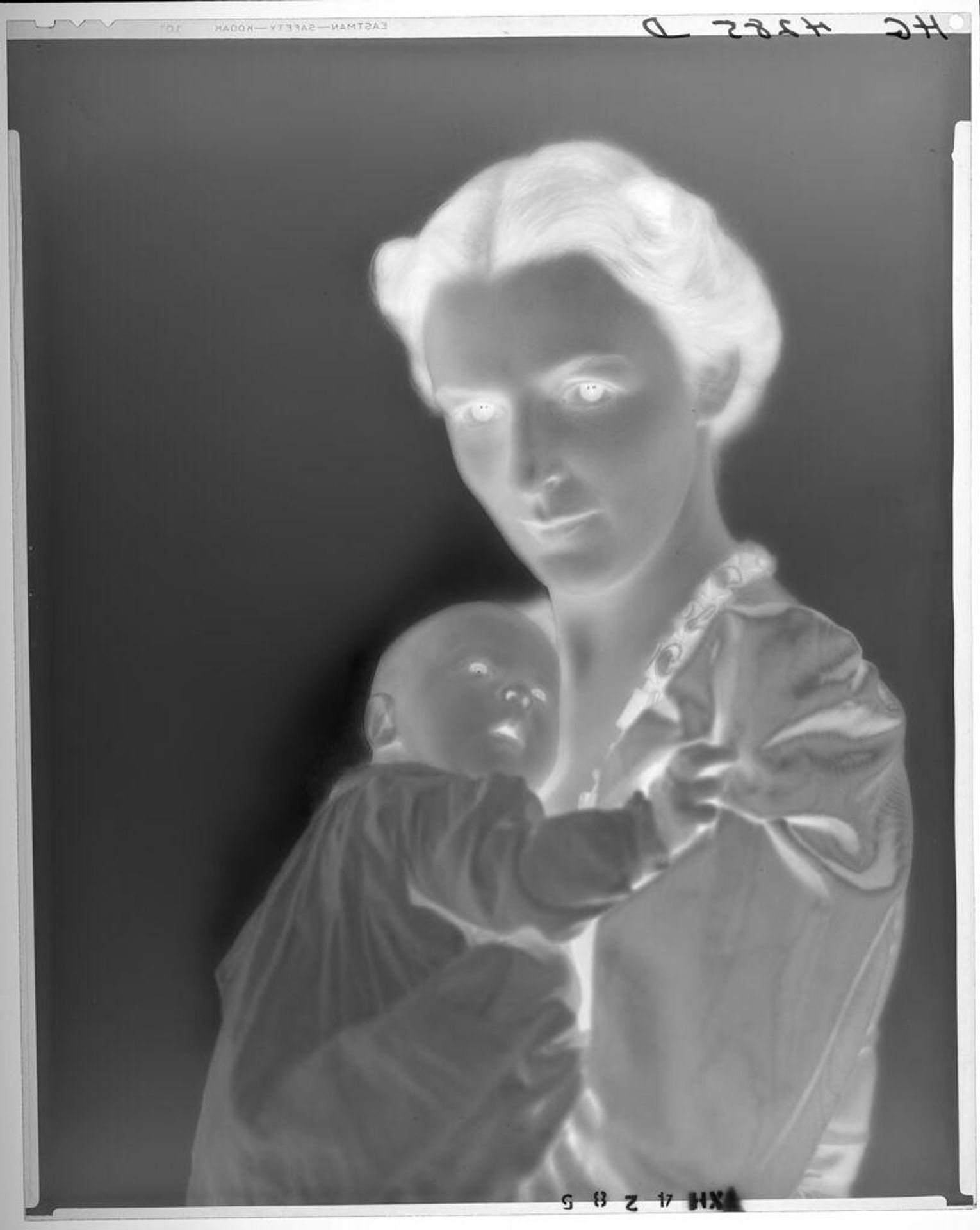 Untitled (woman holding baby to her shoulder) by Paul Gittings