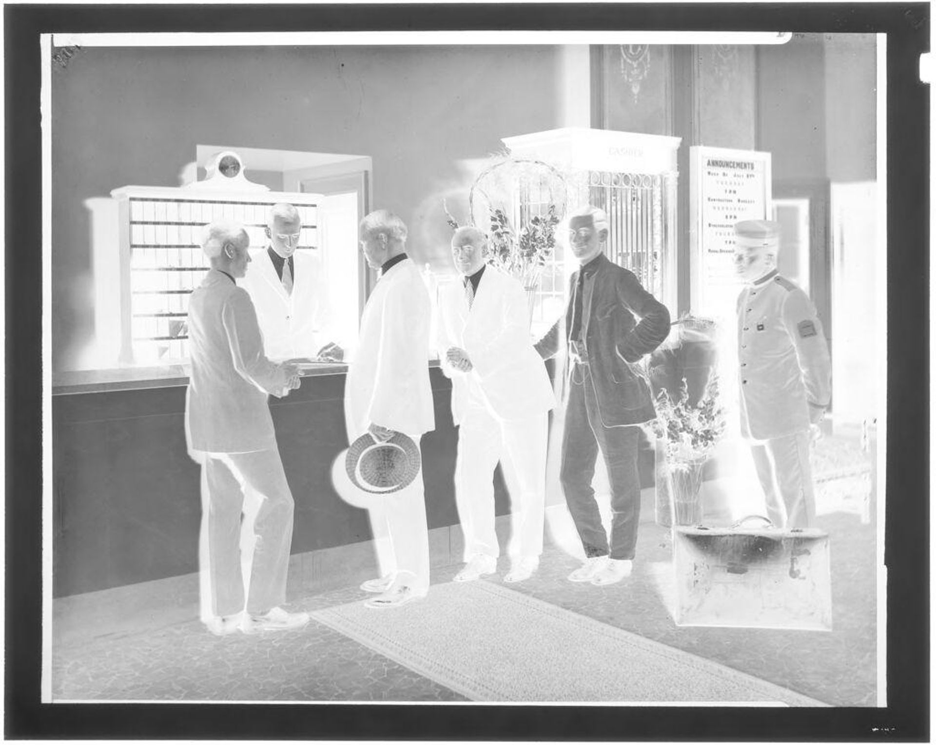 Untitled (men checking in at Elliot Hotel) by Hamblin Studio