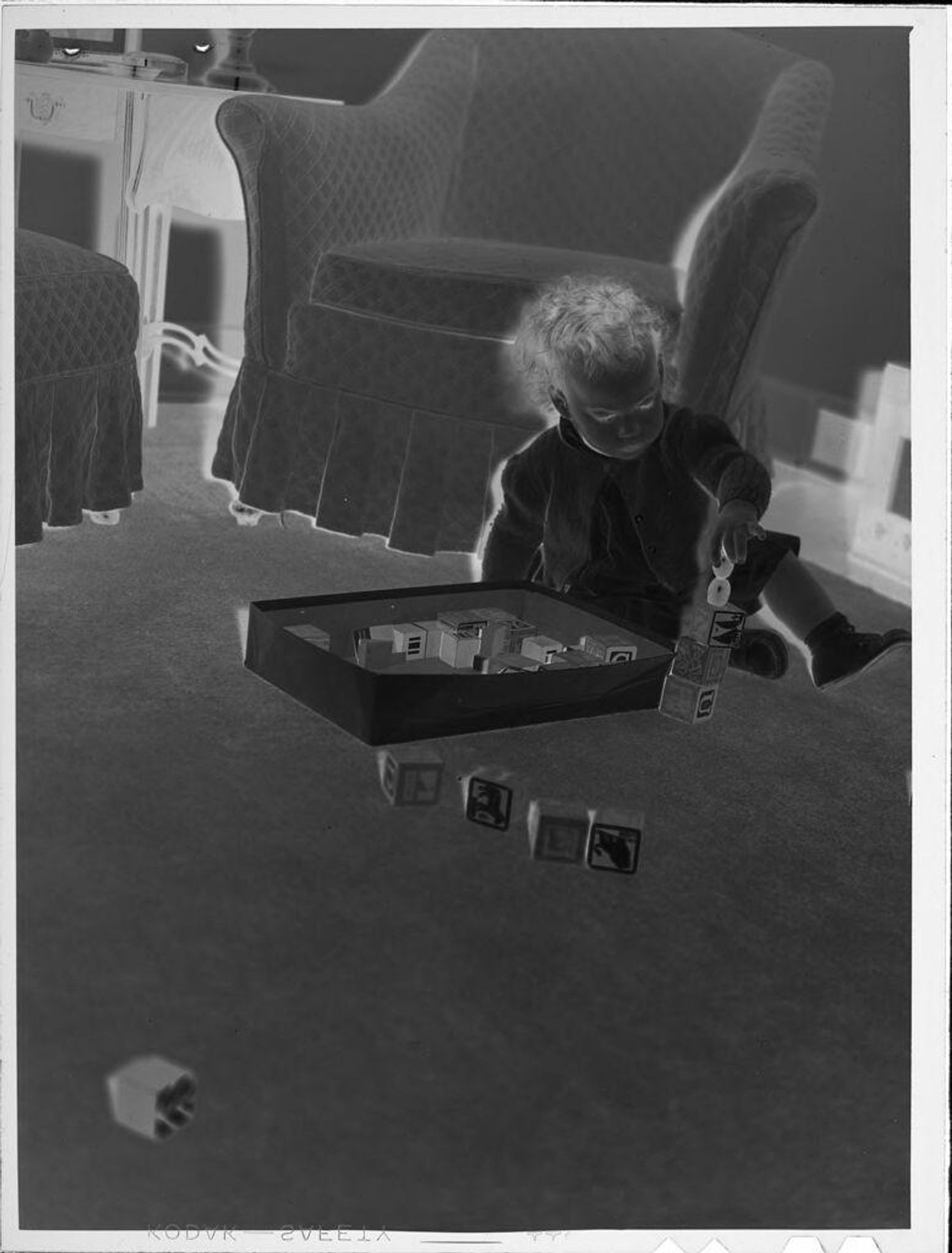 Untitled (baby playing with blocks) by Lucian and Mary Brown
