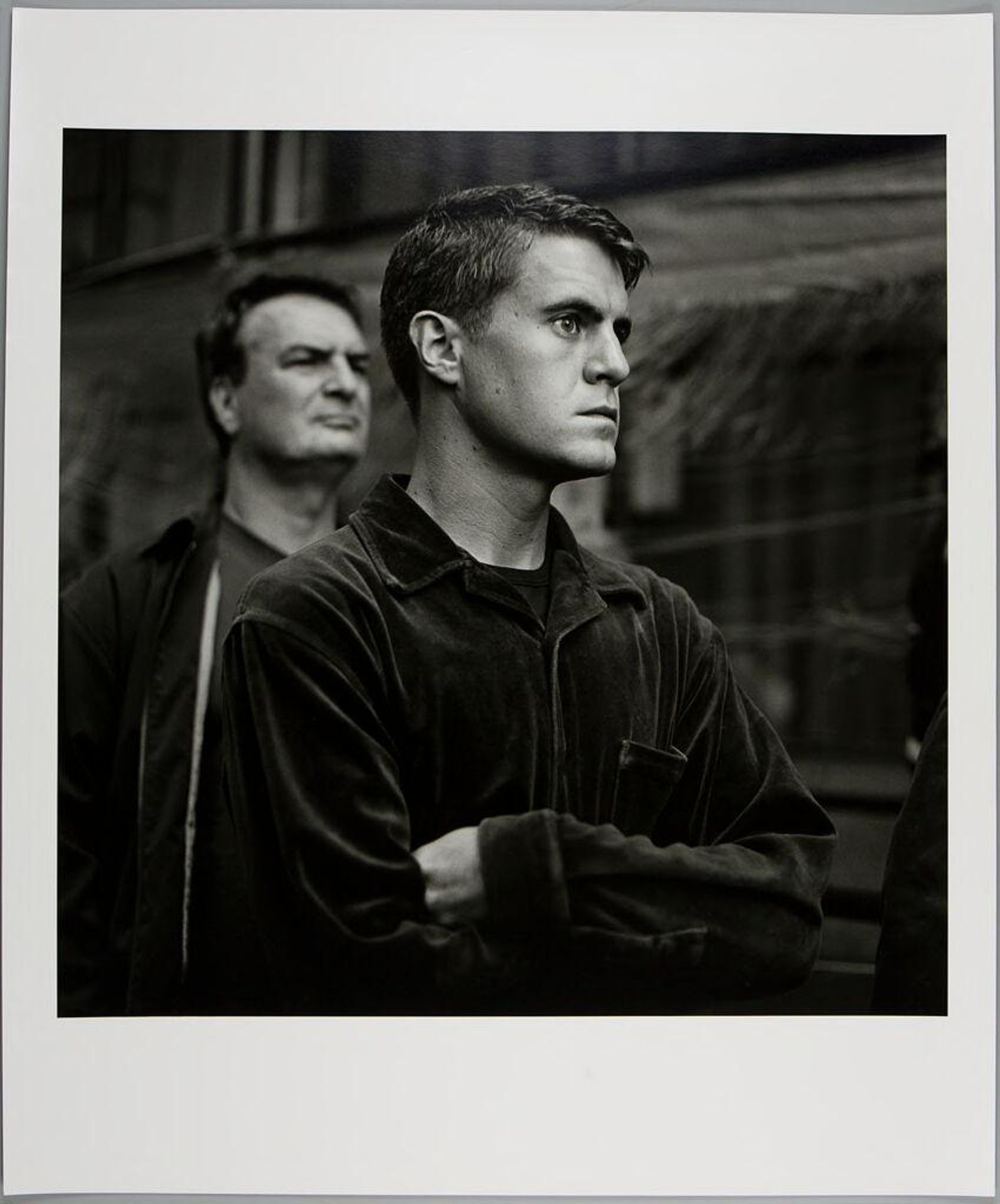 Untitled (portrait of man in profile with arms crossed) by Kevin E. Bubriski