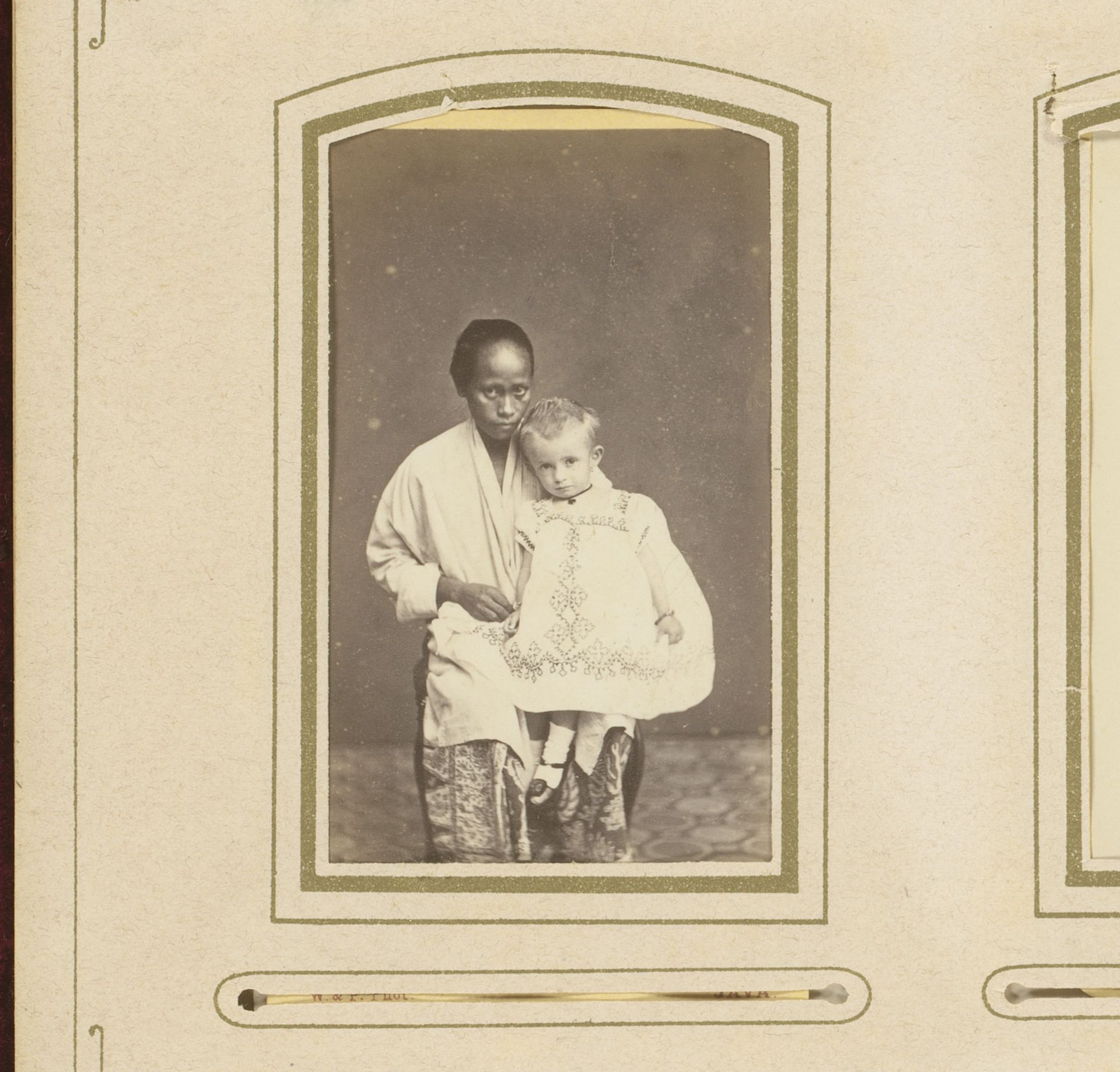 Portrait of an Indonesian Woman with a European Child on Her Lap by Woodbury & Page