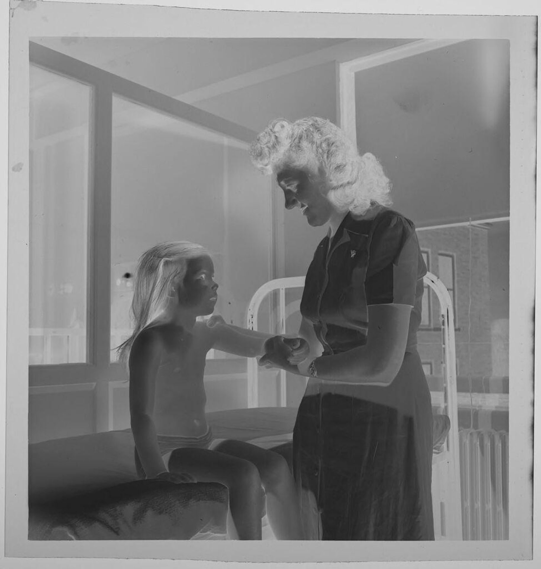 Untitled (nurse attending to arm of child) by Jack Gould