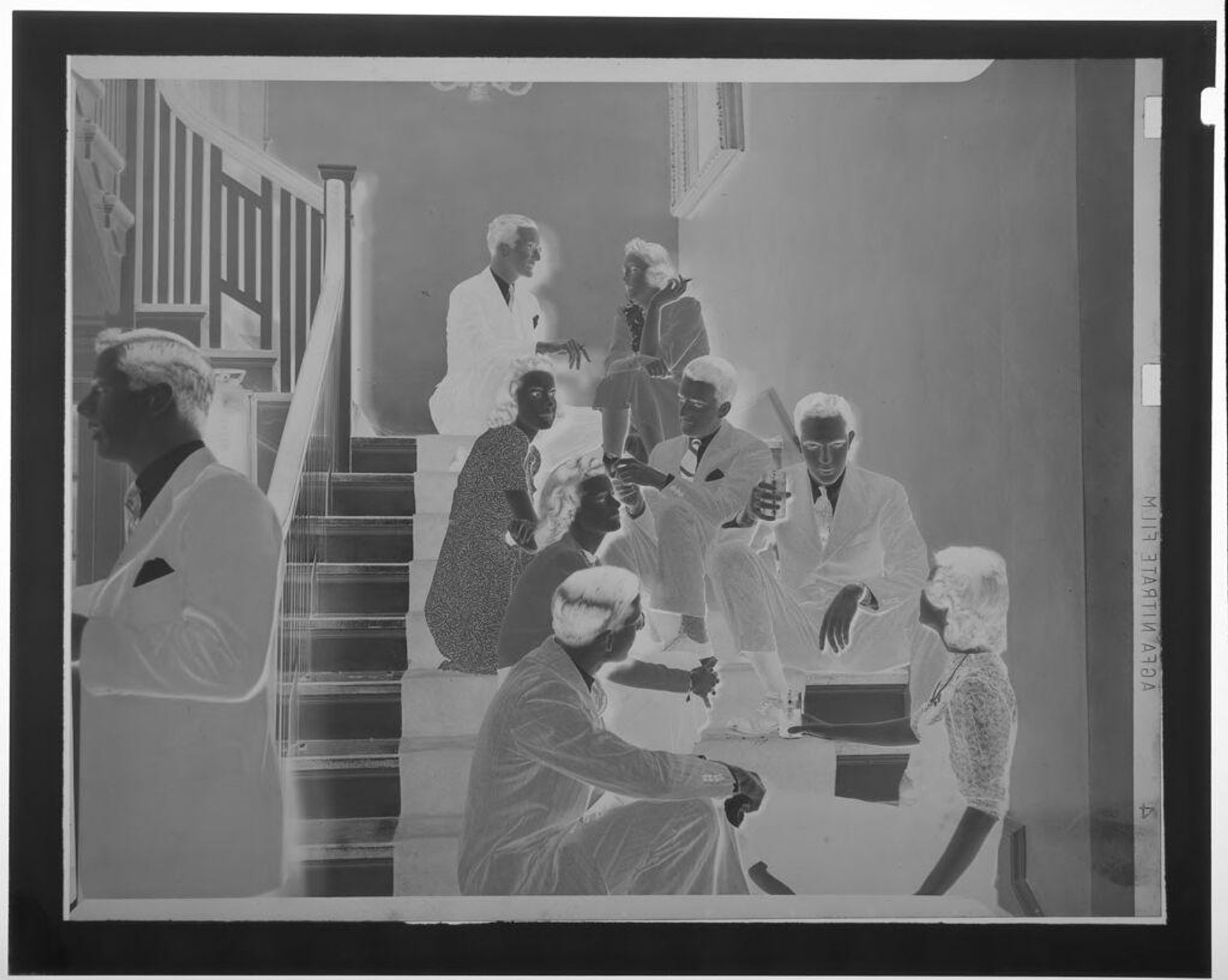 Untitled (seven young men and women sitting, talking, drinking and smoking on stairwell) by Martin Schweig