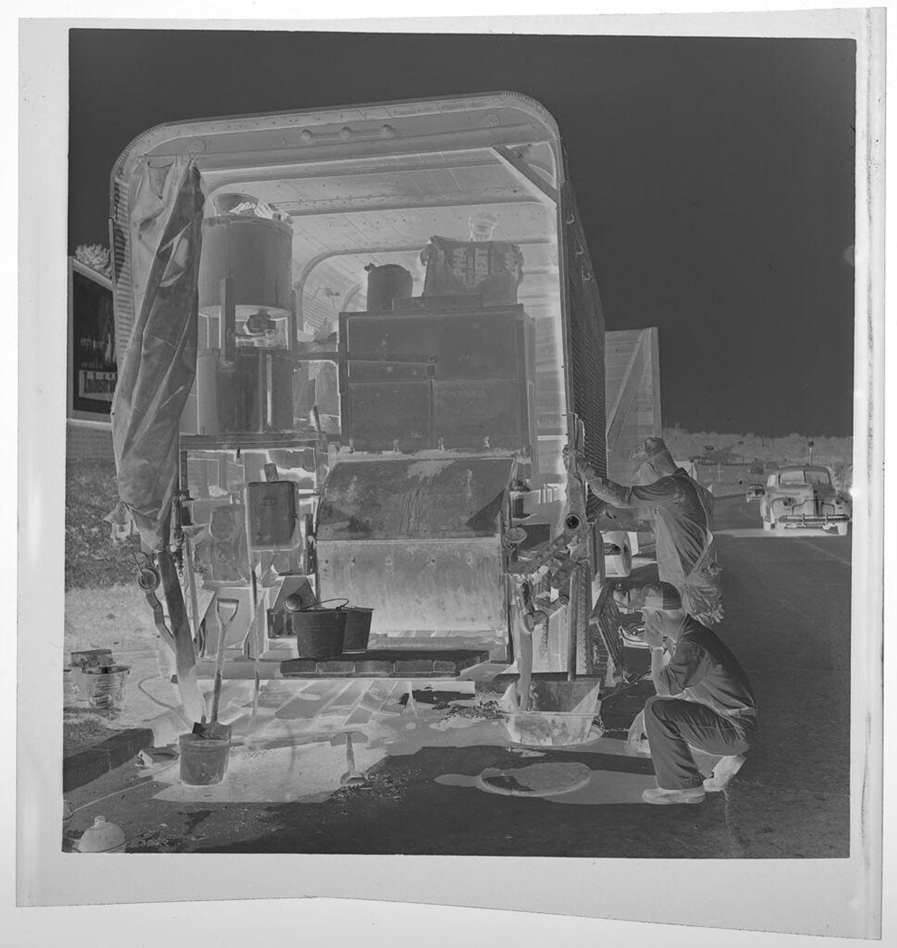 Untitled (men working on machinery digging into street) by Jack Gould