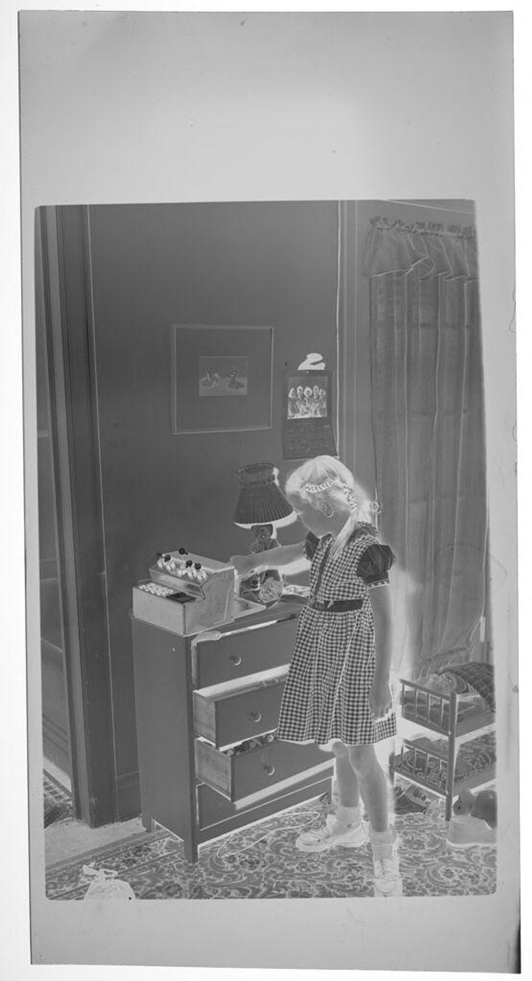 Untitled (girl in gingham dress in bedroom) by Lucian and Mary Brown
